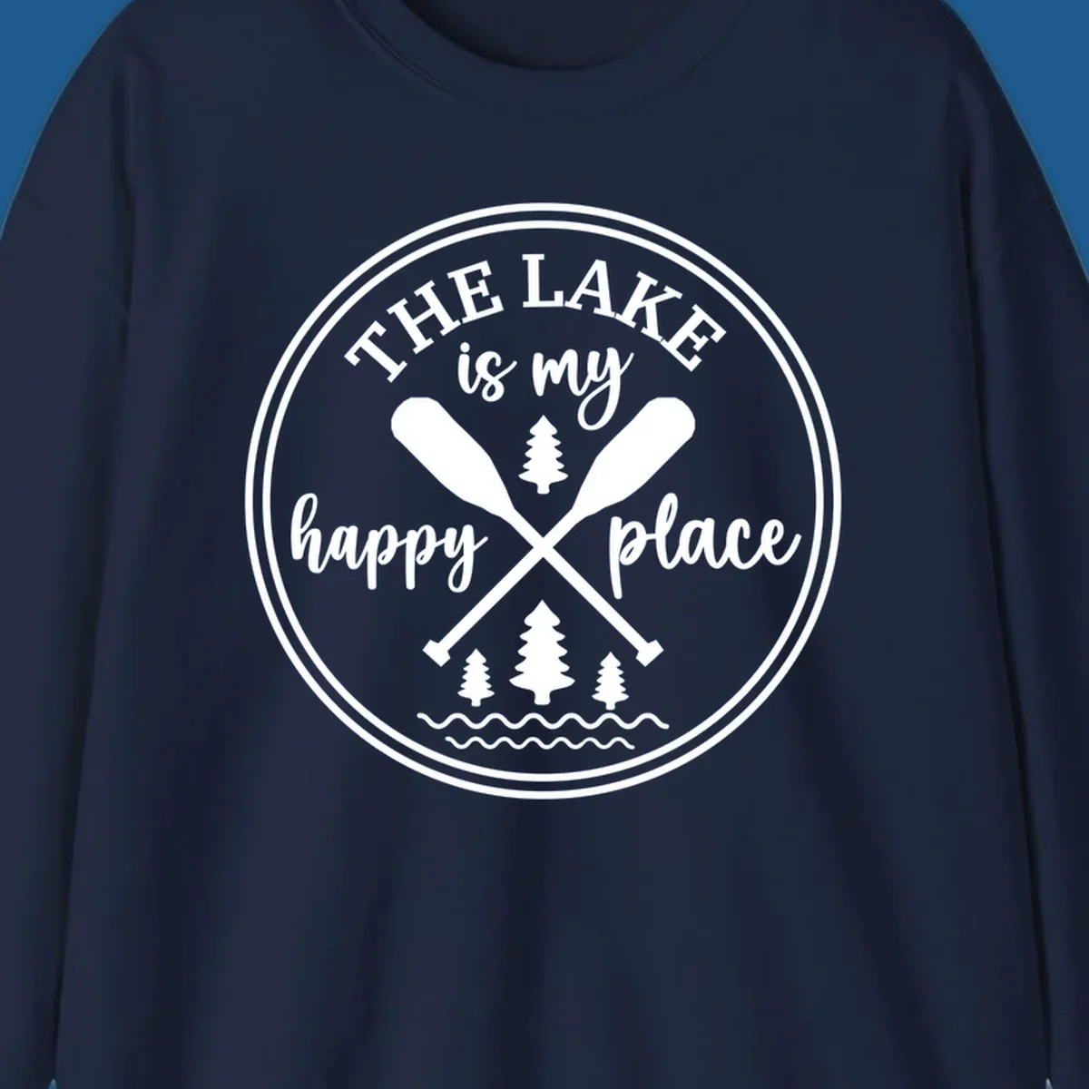 Circular graphic with text 'The Lake is my happy place', crossed oars, and pine trees - lake-happy-place.