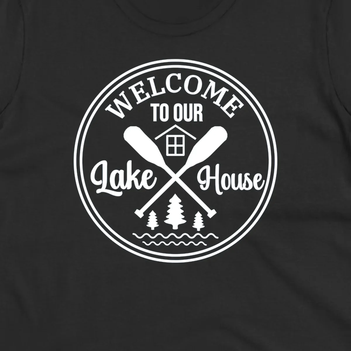 Circular badge design with text 'WELCOME TO OUR Lake House', crossed oars, house, trees, and waves.