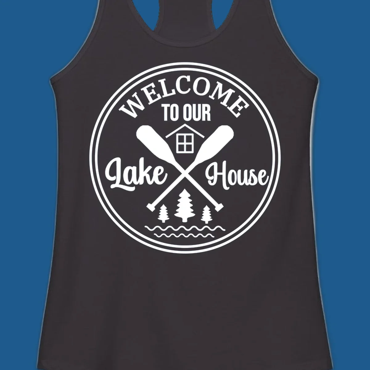 Circular badge design with text 'WELCOME TO OUR Lake House', crossed oars, house, trees, and waves.