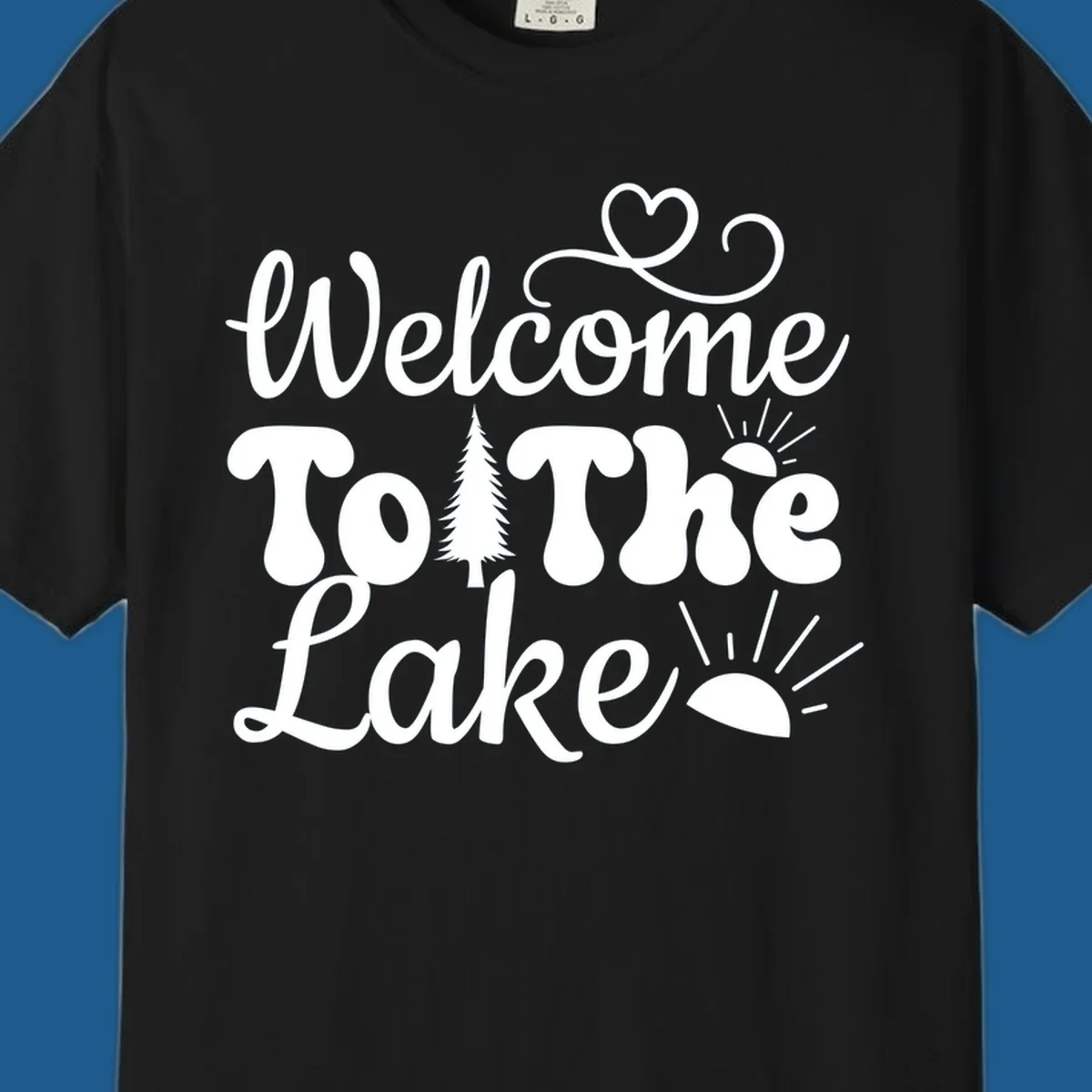 Welcome to the lake typography design with tree and sun graphics.