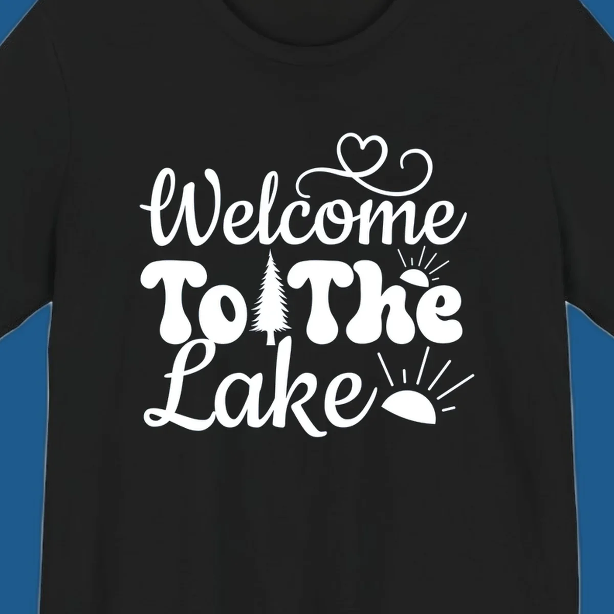 Welcome to the lake typography design with tree and sun graphics.