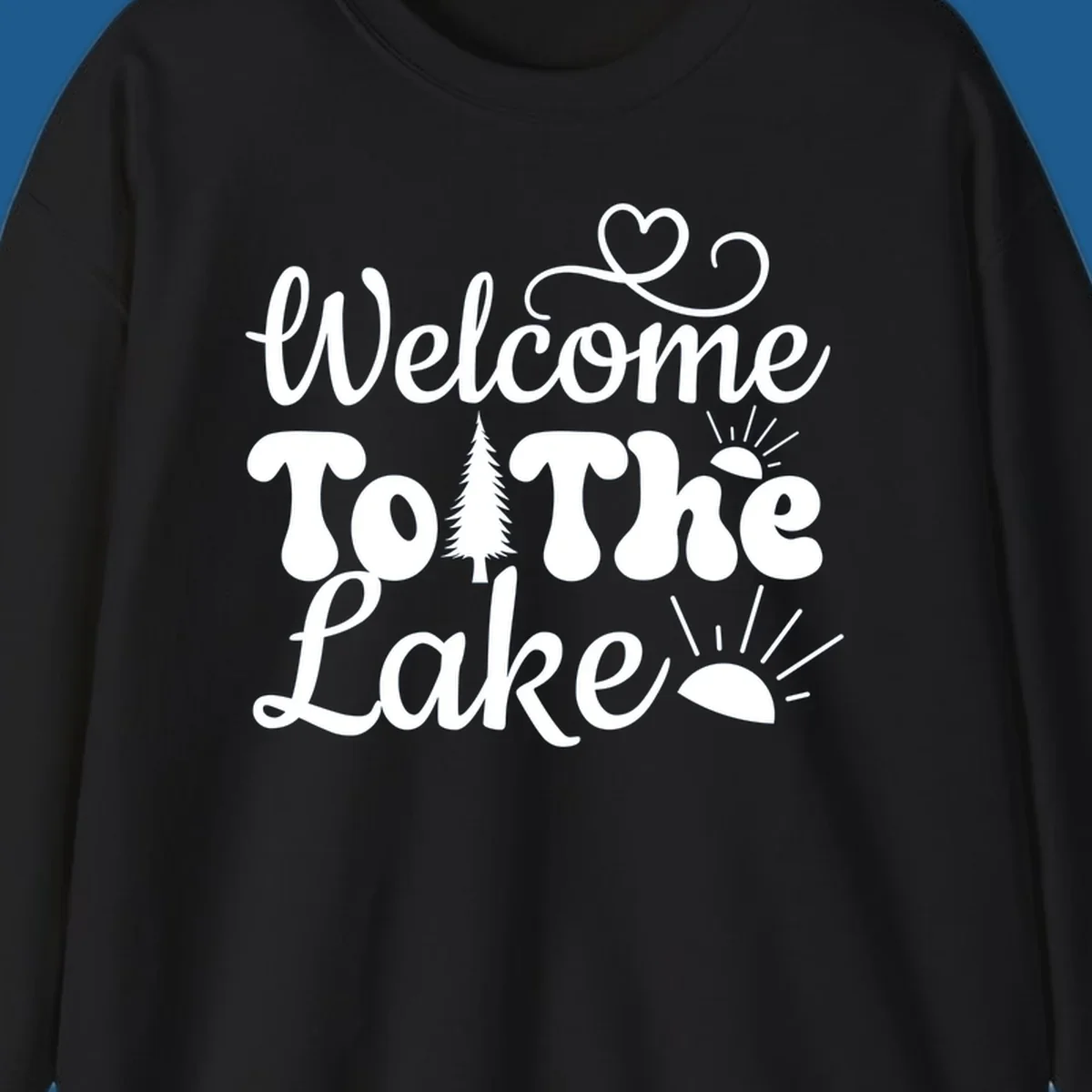Welcome to the lake typography design with tree and sun graphics.