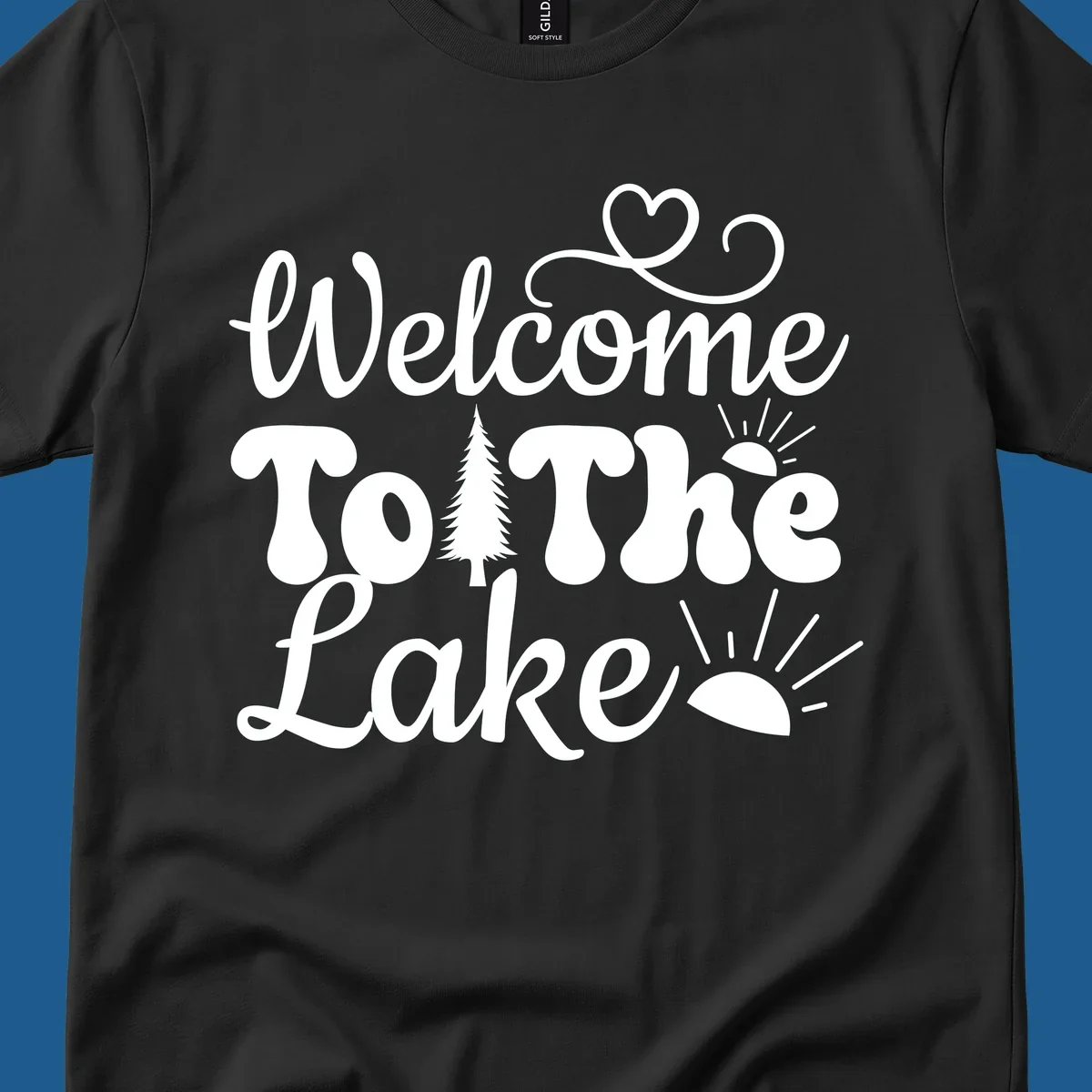 Welcome to the lake typography design with tree and sun graphics.
