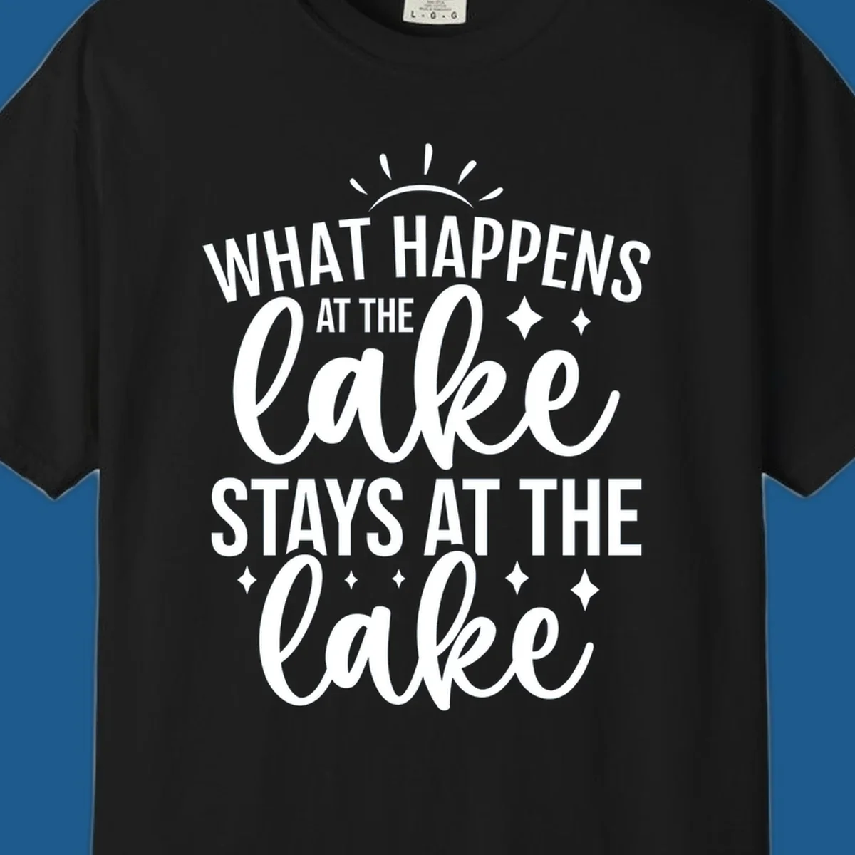 What happens at the lake stays at the lake typography design with sun rays and sparkles.