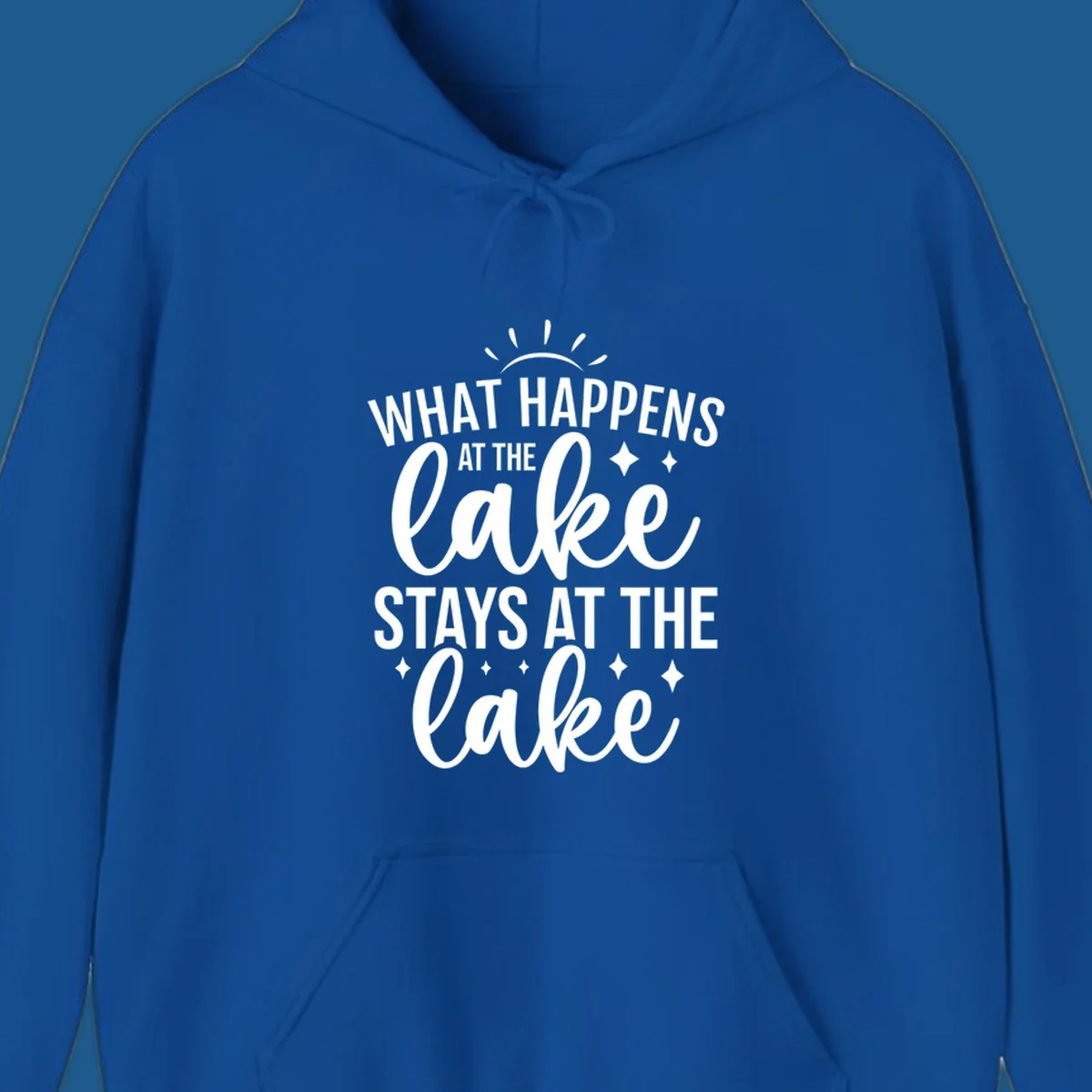 What happens at the lake stays at the lake typography design with sun rays and sparkles.
