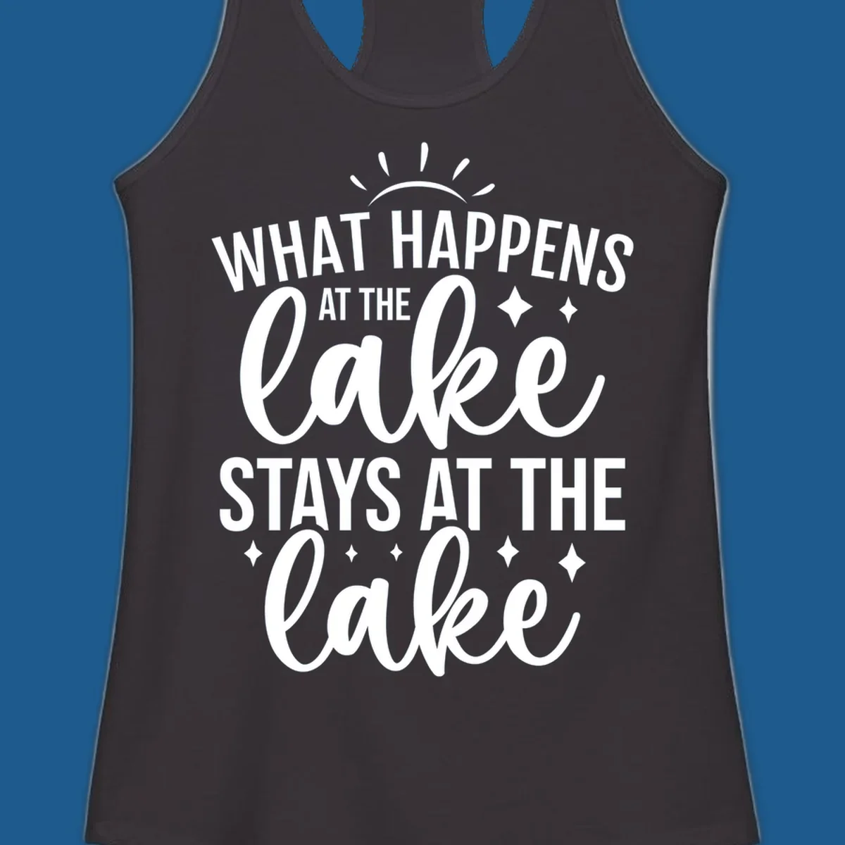 What happens at the lake stays at the lake typography design with sun rays and sparkles.