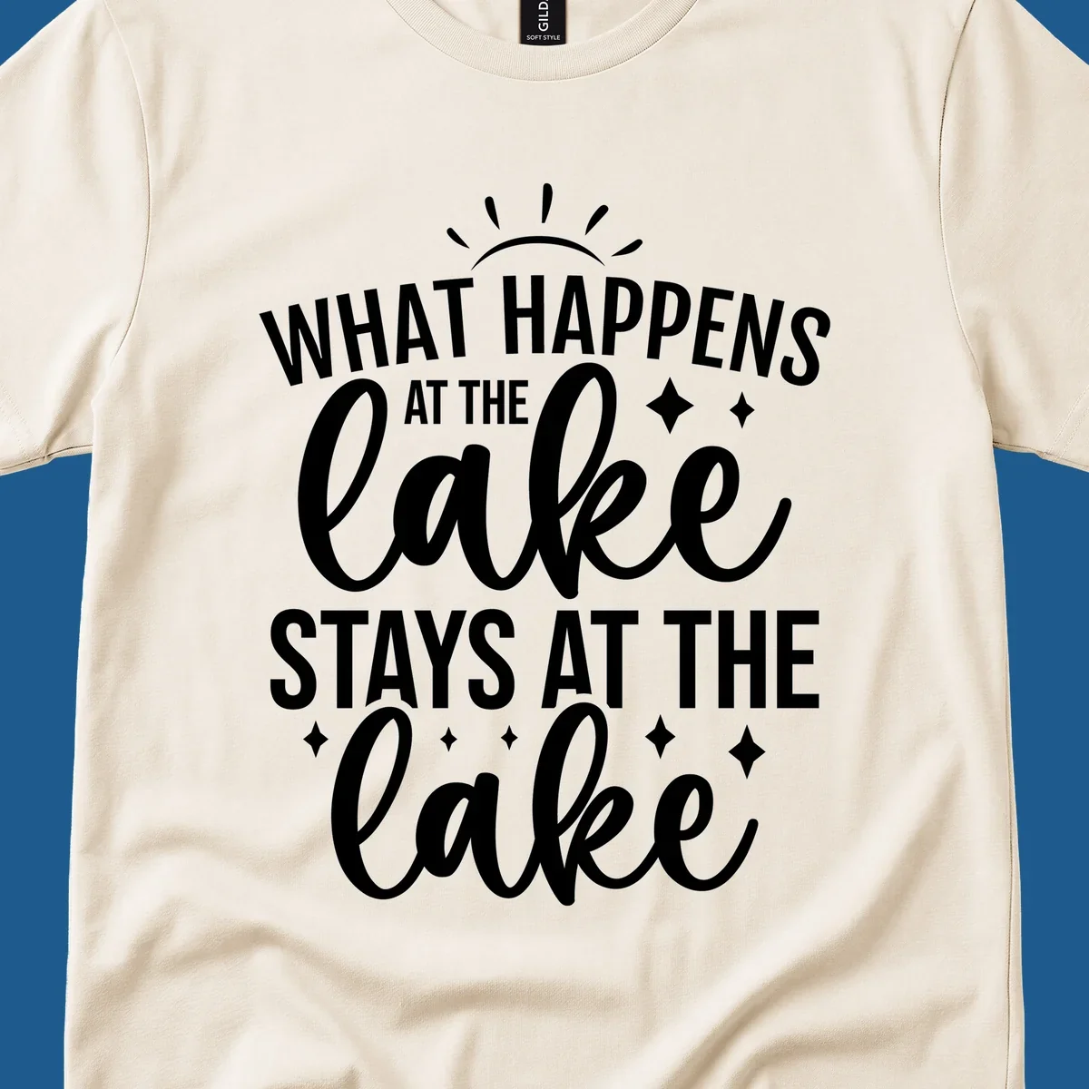 What happens at the lake stays at the lake typography design with sun rays and sparkles.