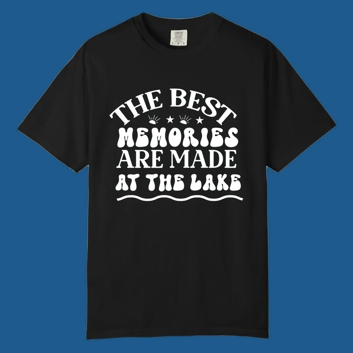 Retro typography design 'The Best Memories Are Made At The Lake' with sun rays and stars.