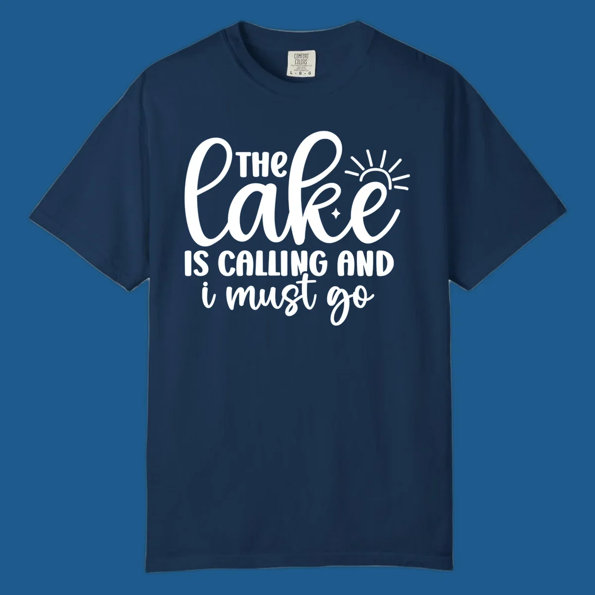 The lake is calling and I must go text with sun and star graphic