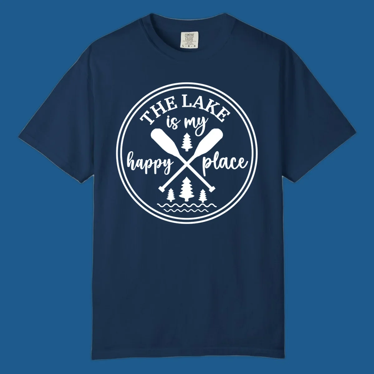 Circular graphic with text 'The Lake is my happy place', crossed oars, and pine trees - lake-happy-place.