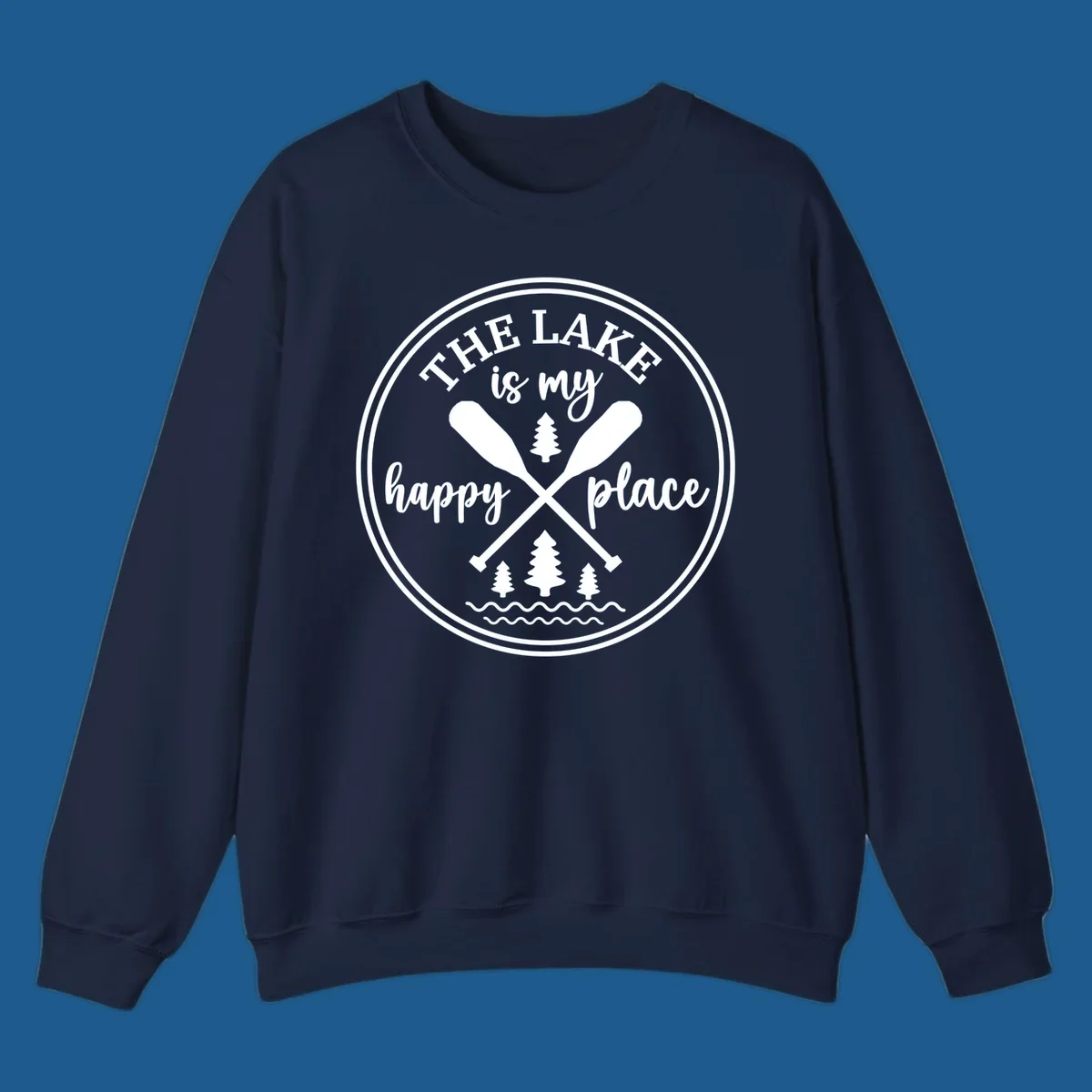 Circular graphic with text 'The Lake is my happy place', crossed oars, and pine trees - lake-happy-place.