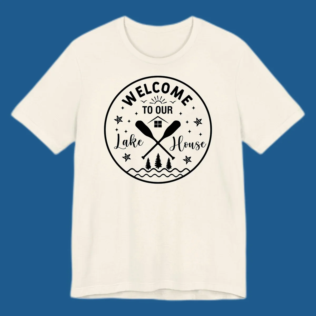 Welcome to our lake house circular design with oars, house, trees, and text.