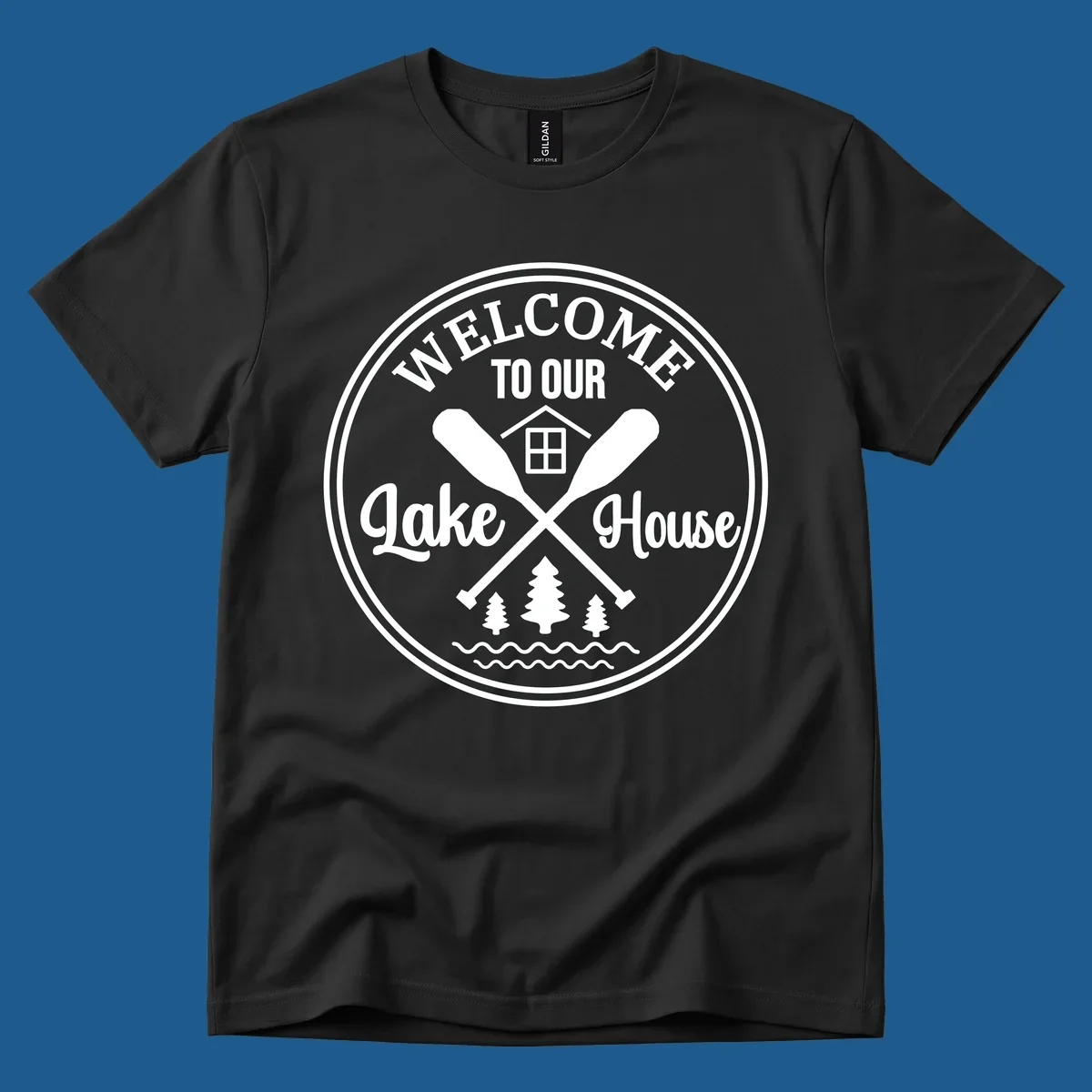 Circular badge design with text 'WELCOME TO OUR Lake House', crossed oars, house, trees, and waves.