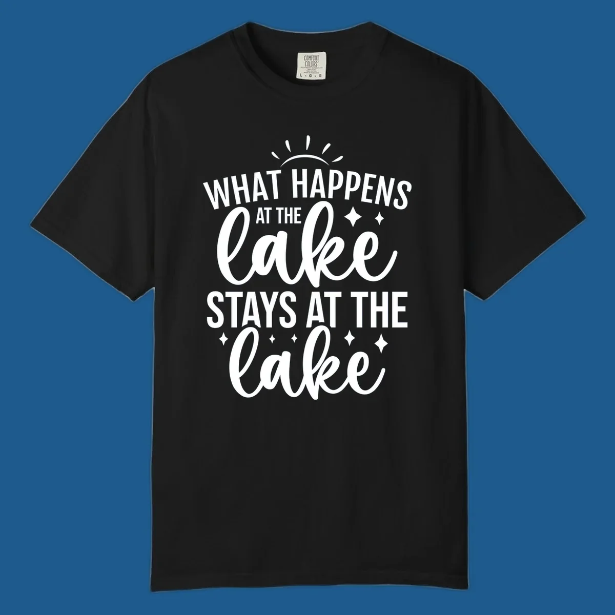 What happens at the lake stays at the lake typography design with sun rays and sparkles.