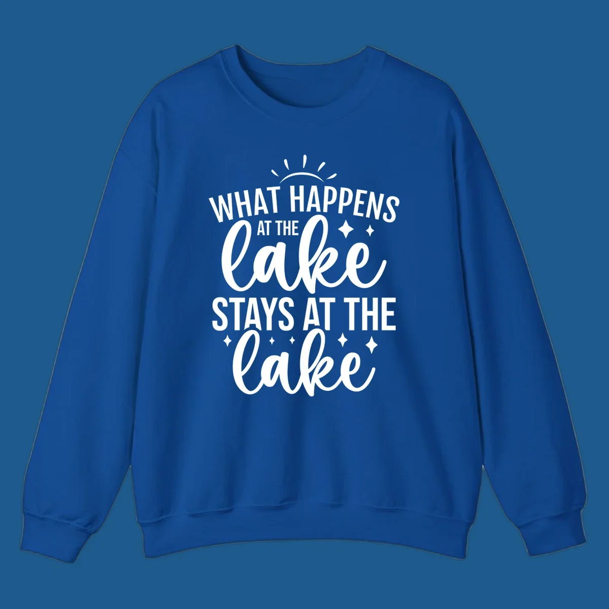 What happens at the lake stays at the lake typography design with sun rays and sparkles.