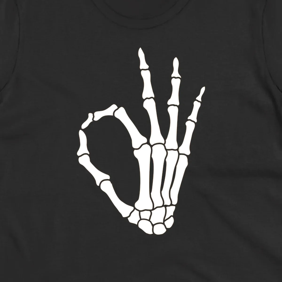 A white skeleton hand forms the 'okay' sign, with thumb and index finger creating a circle. A minimalist skeleton-hand-okay-sign.