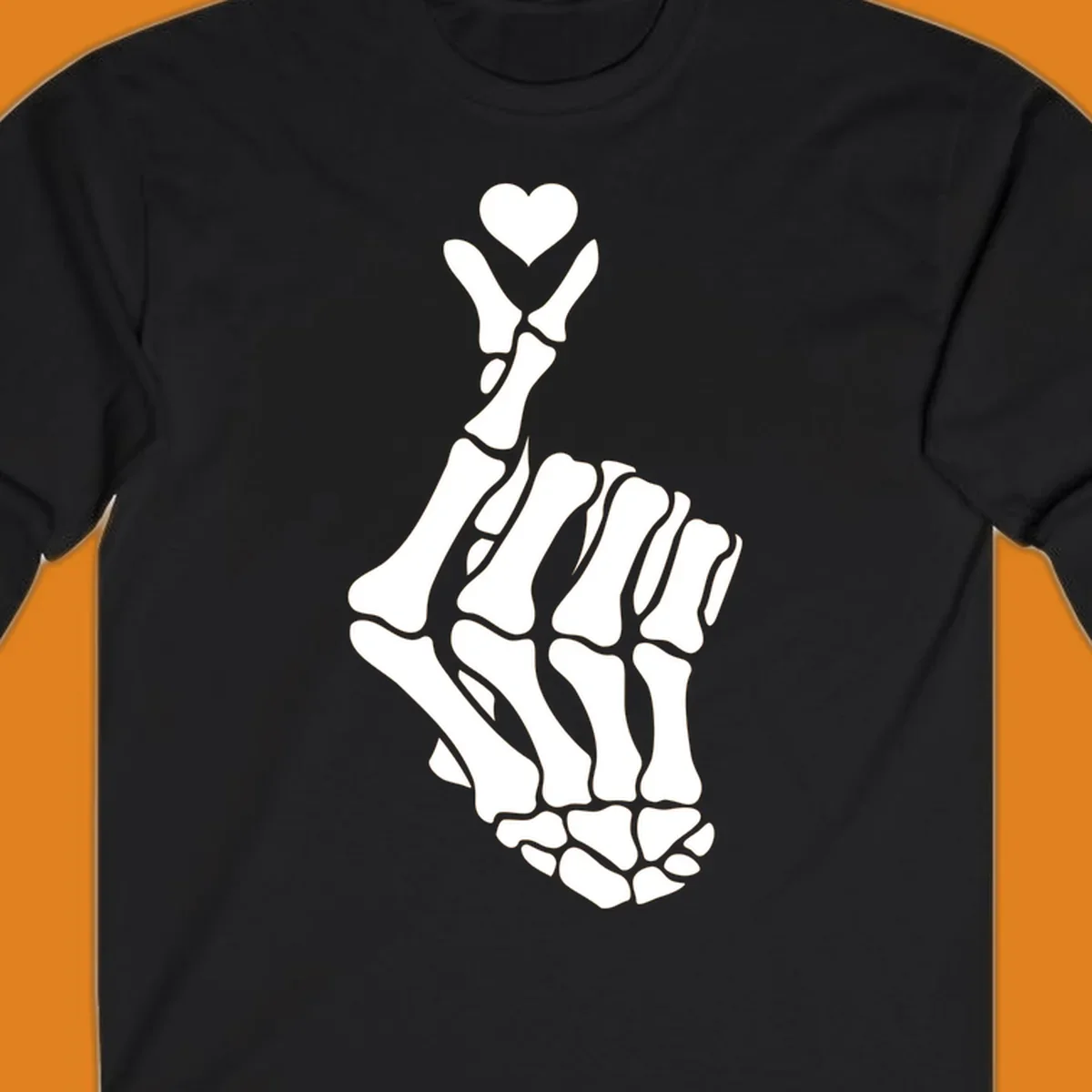 A white skeleton hand forms the Korean finger heart gesture, with a small heart shape at the fingertips. Concept: skeleton-finger-heart.