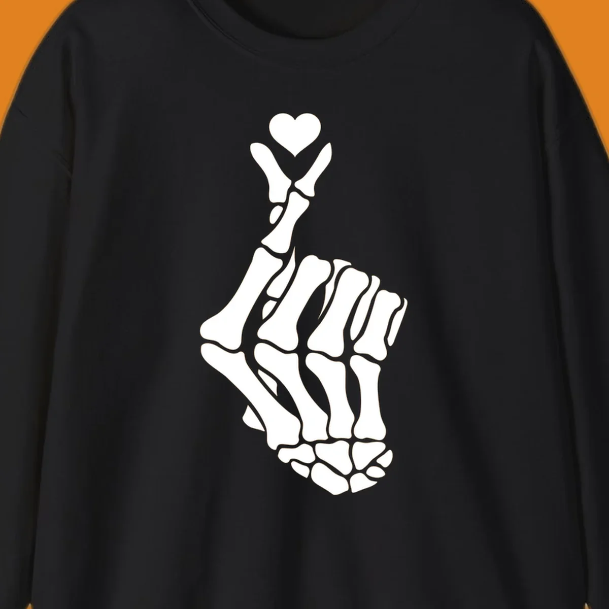 A white skeleton hand forms the Korean finger heart gesture, with a small heart shape at the fingertips. Concept: skeleton-finger-heart.