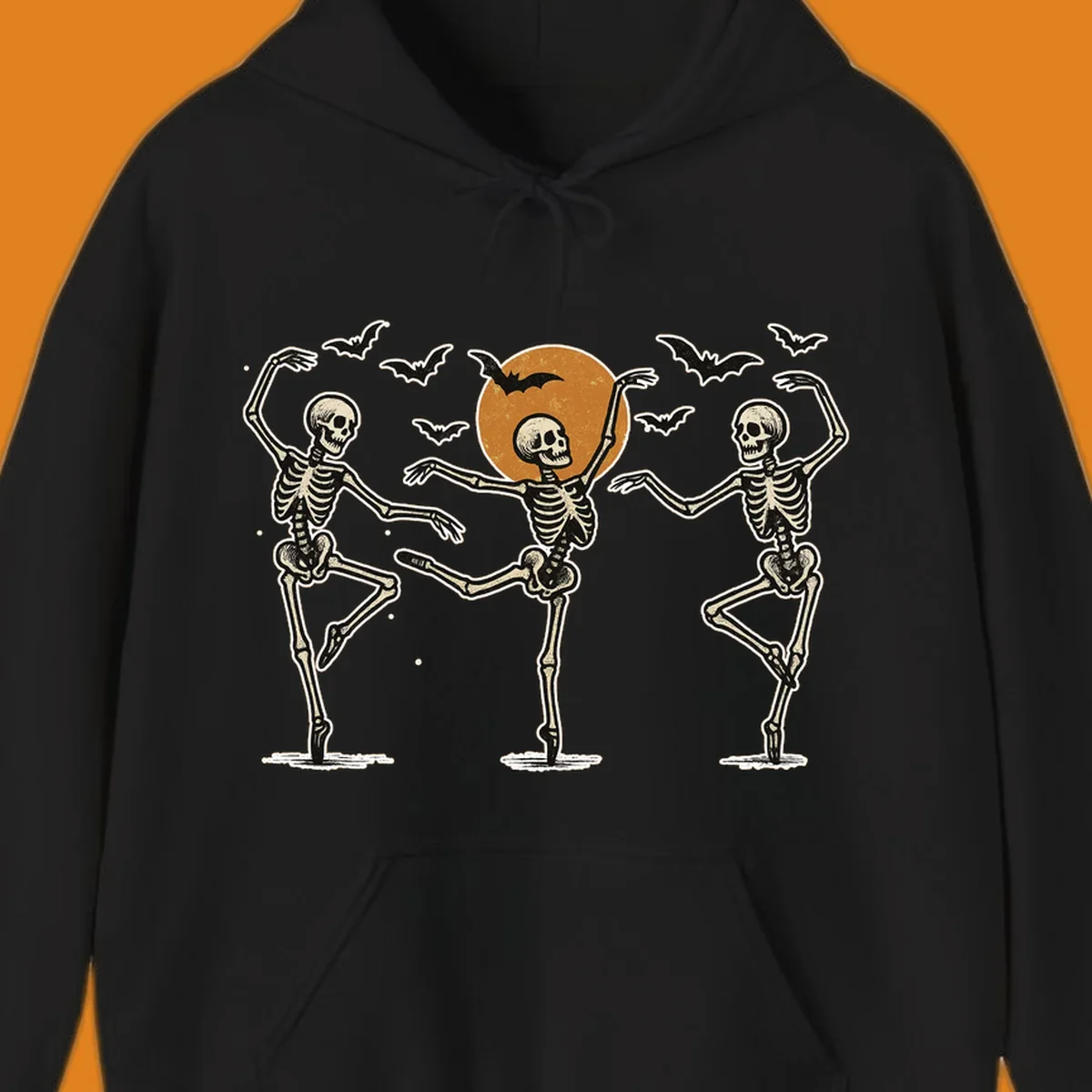 Vintage illustration of three dancing skeletons under a Halloween moon with bats, evoking a spooky ballet.