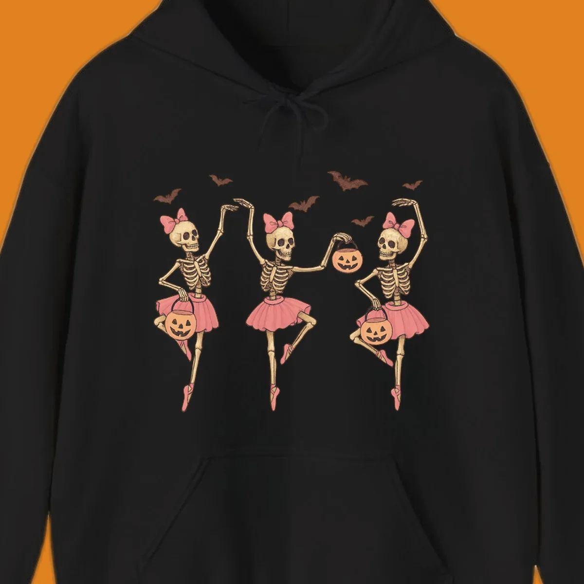 Skeleton ballerinas in tutus with pumpkins and bats, perfect for Halloween.