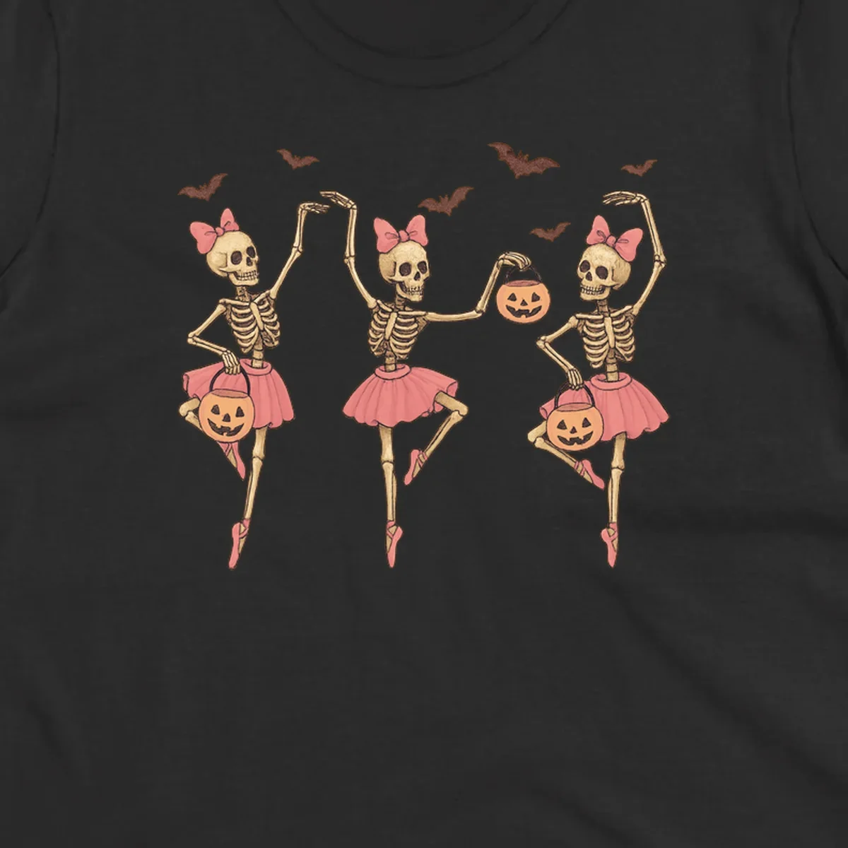 Skeleton ballerinas in tutus with pumpkins and bats, perfect for Halloween.