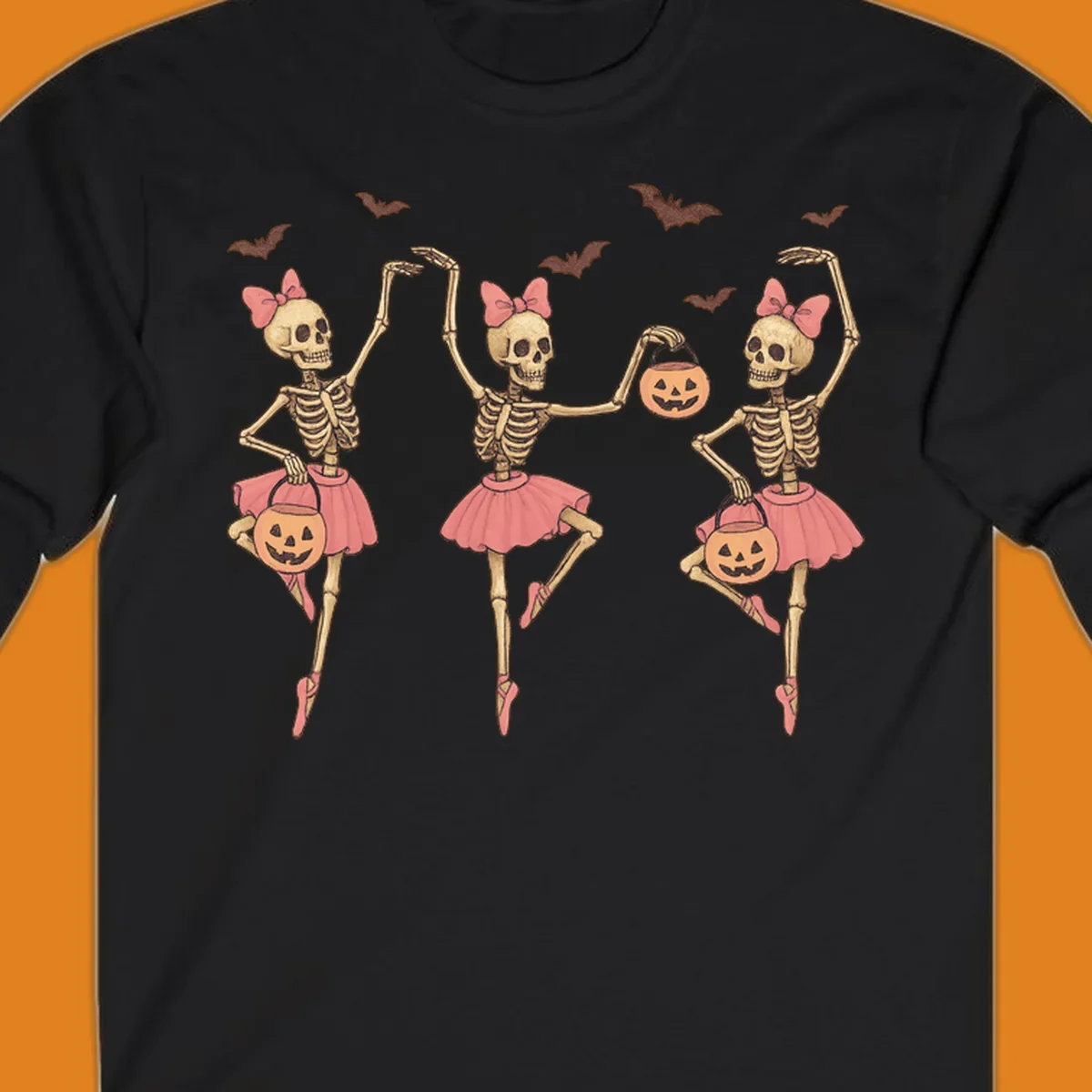 Skeleton ballerinas in tutus with pumpkins and bats, perfect for Halloween.