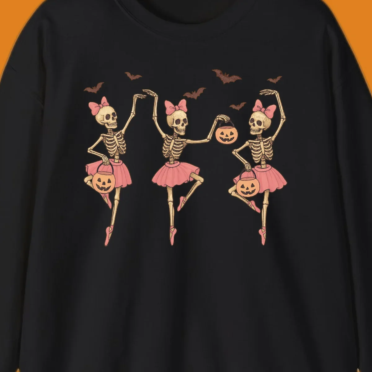 Skeleton ballerinas in tutus with pumpkins and bats, perfect for Halloween.