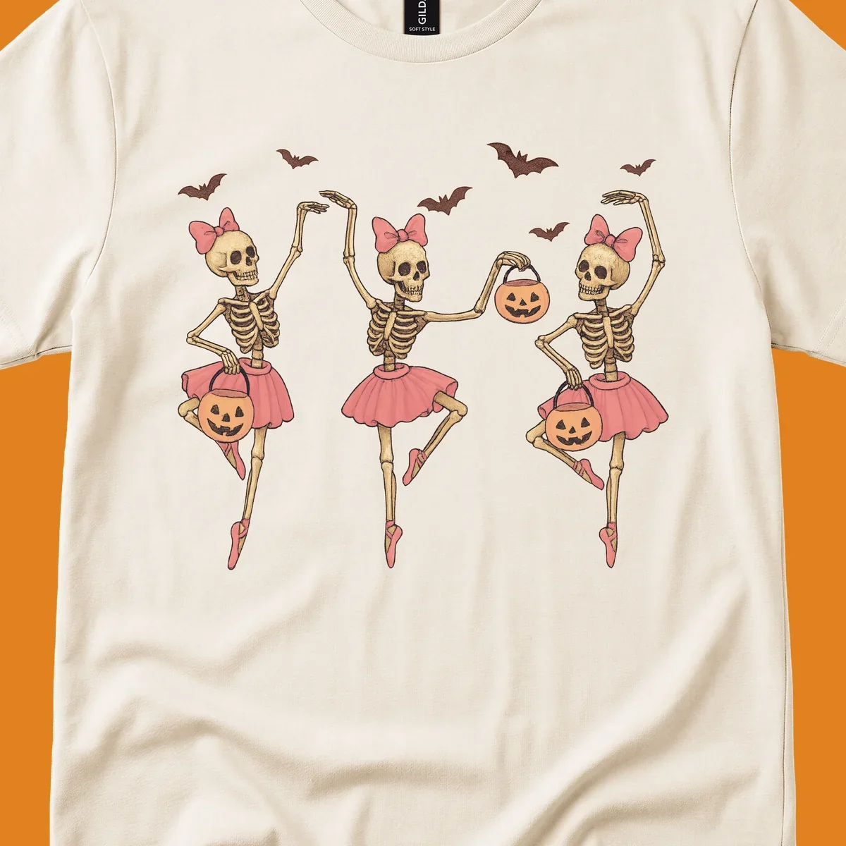 Skeleton ballerinas in tutus with pumpkins and bats, perfect for Halloween.