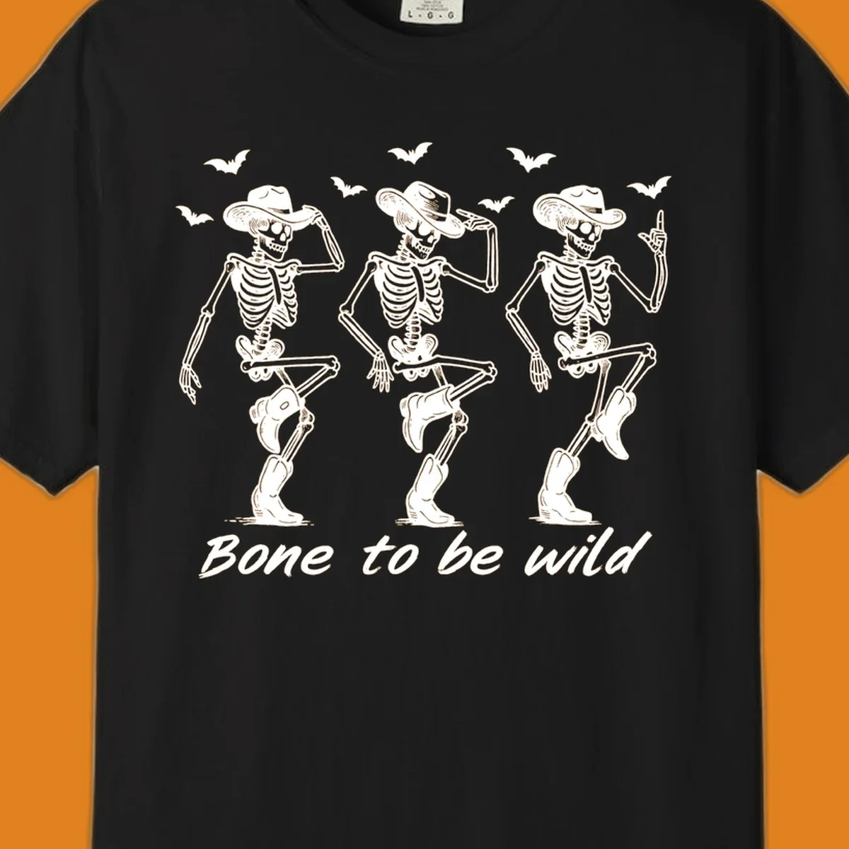 Three dancing skeletons in cowboy hats and boots with bats and the phrase 'Bone to be wild', bone-to-be-wild-cowboy