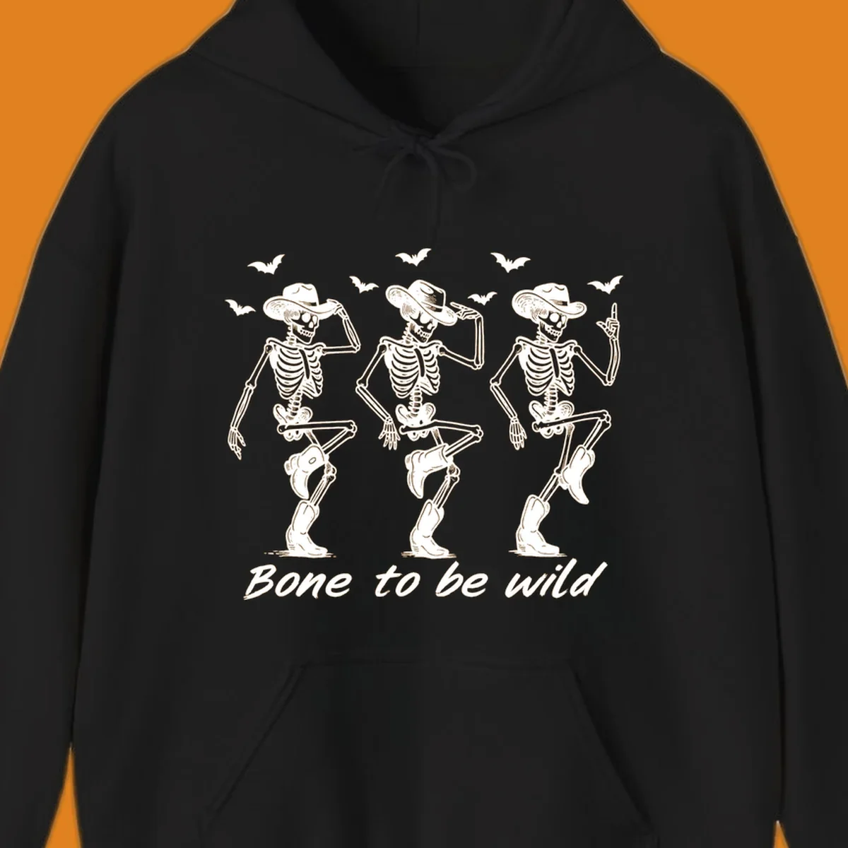 Three dancing skeletons in cowboy hats and boots with bats and the phrase 'Bone to be wild', bone-to-be-wild-cowboy