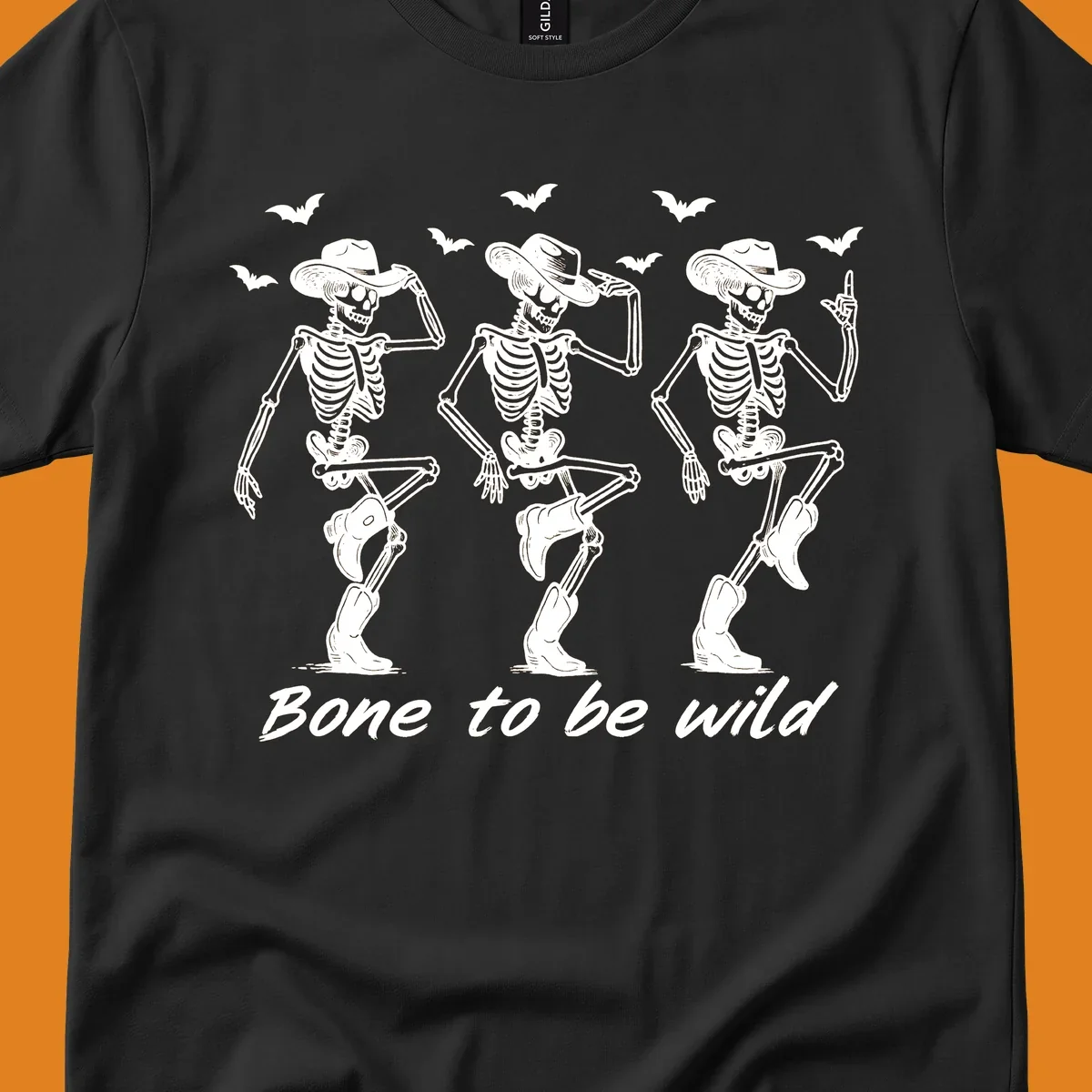 Three dancing skeletons in cowboy hats and boots with bats and the phrase 'Bone to be wild', bone-to-be-wild-cowboy