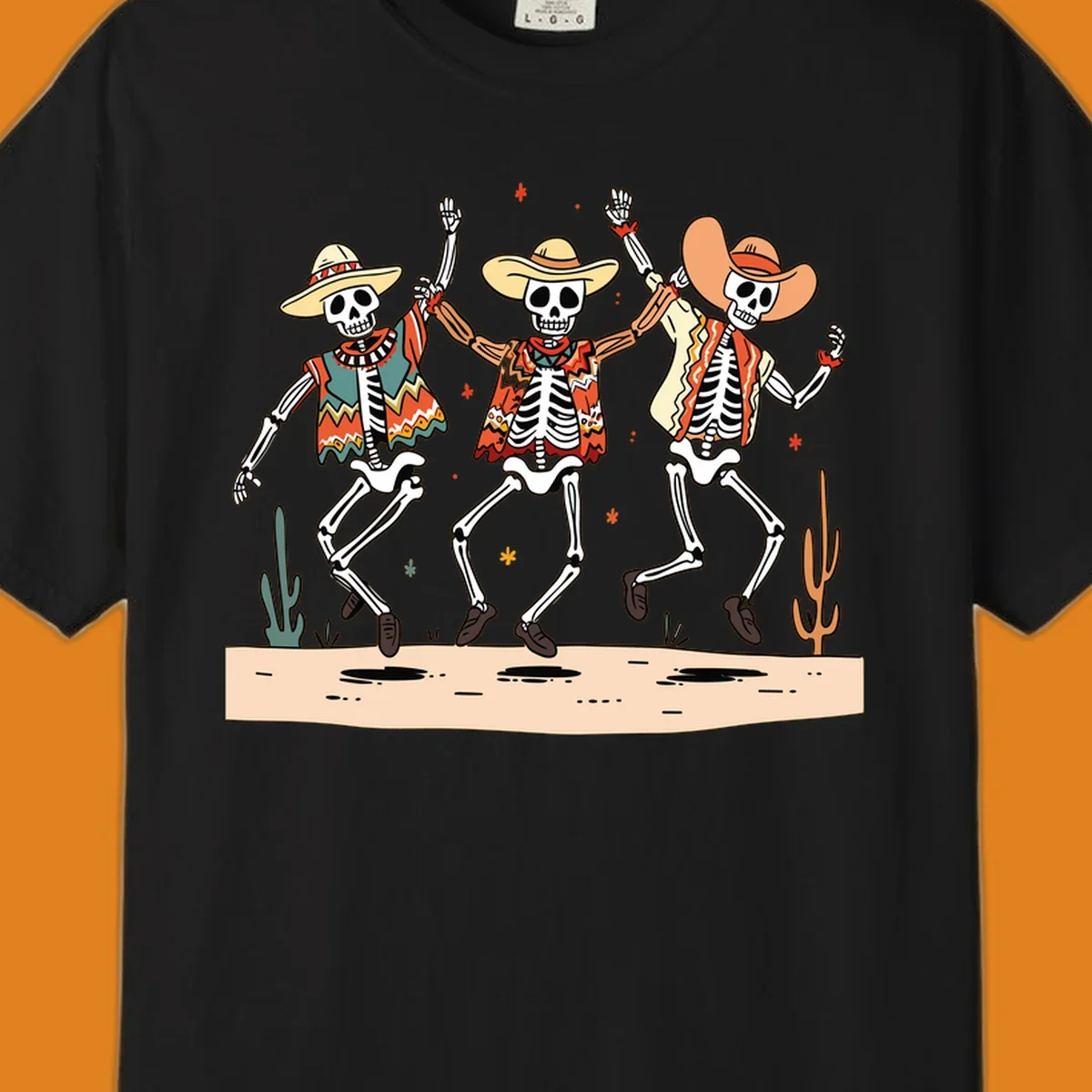 Three dancing skeletons in festive Mexican attire and sombreros, against a dark background with desert elements.
