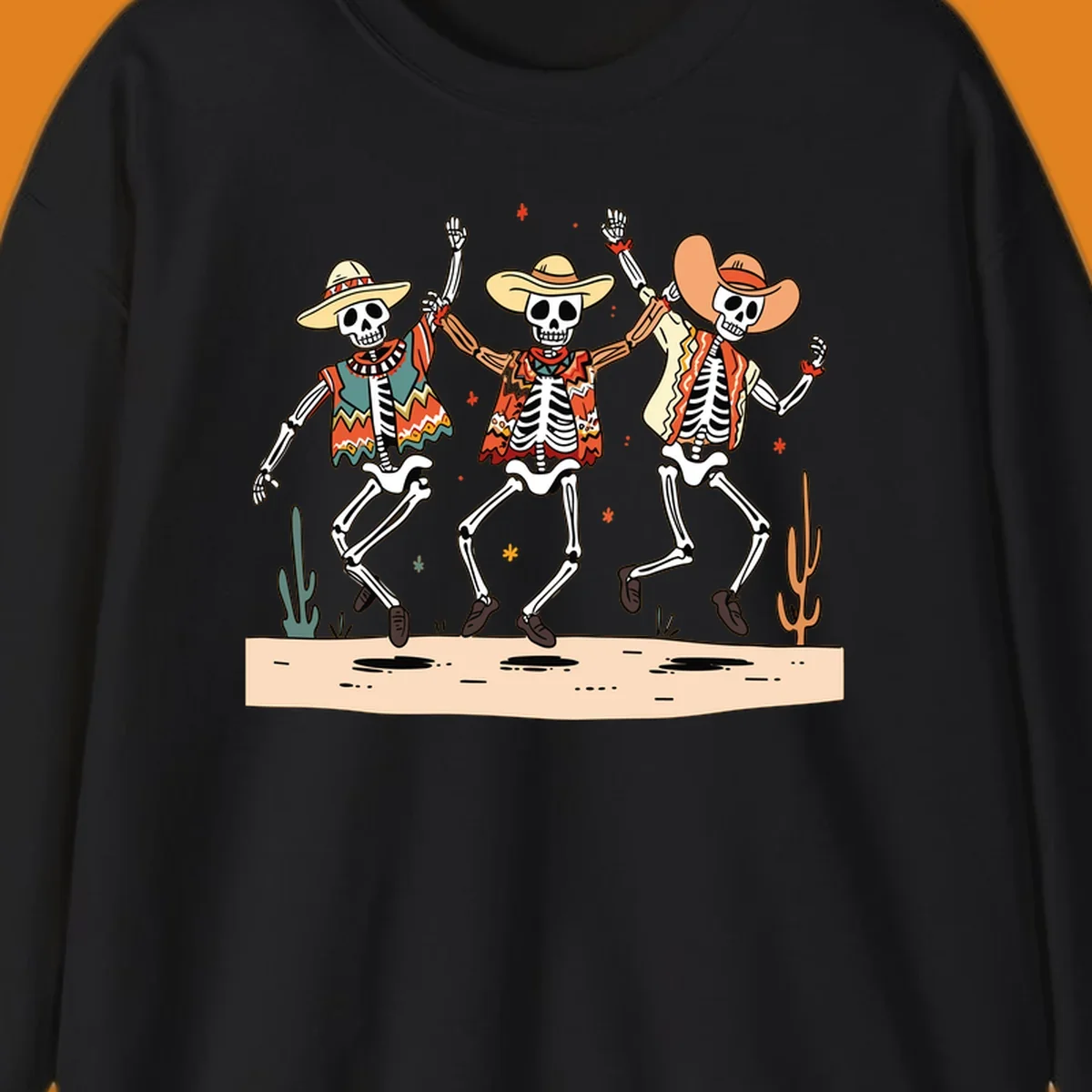 Three dancing skeletons in festive Mexican attire and sombreros, against a dark background with desert elements.
