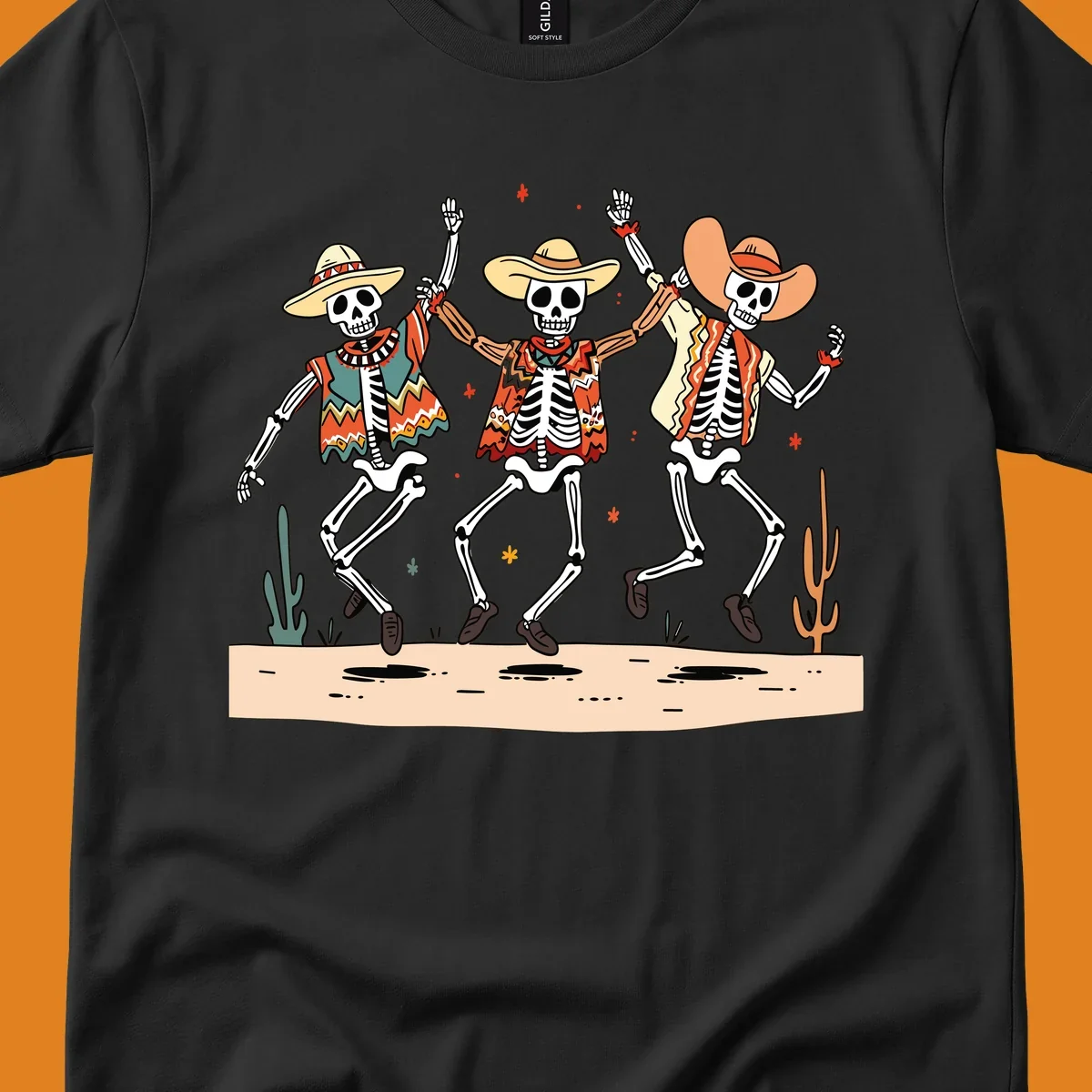 Three dancing skeletons in festive Mexican attire and sombreros, against a dark background with desert elements.