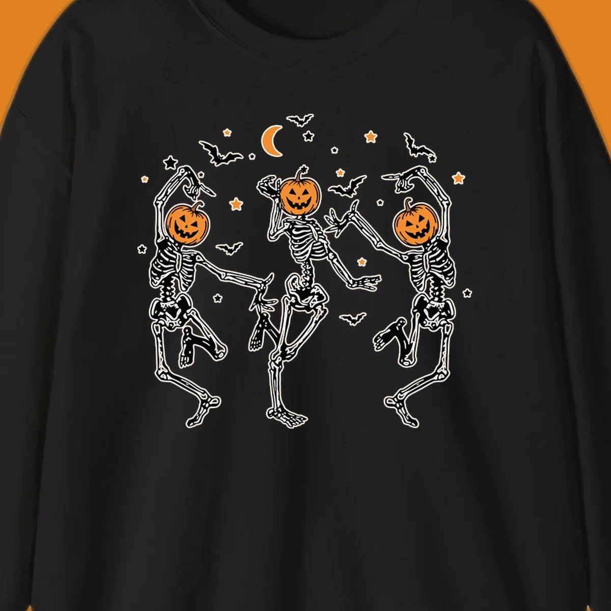 Three dancing skeletons with pumpkin heads, bats, moon, and stars illustration for Halloween.