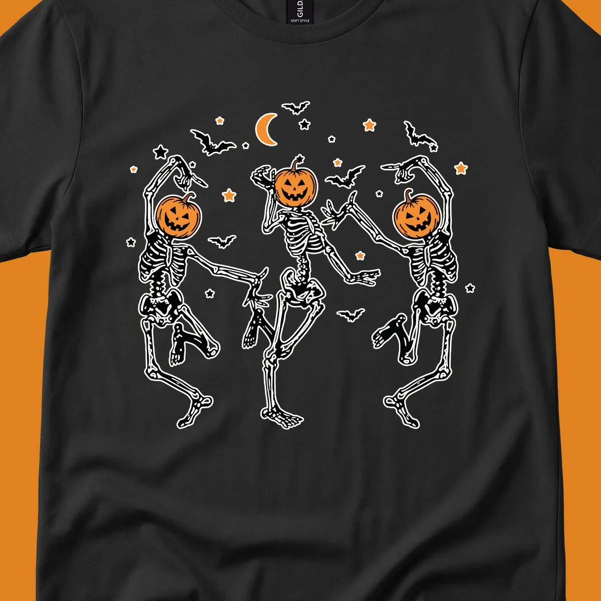 Three dancing skeletons with pumpkin heads, bats, moon, and stars illustration for Halloween.