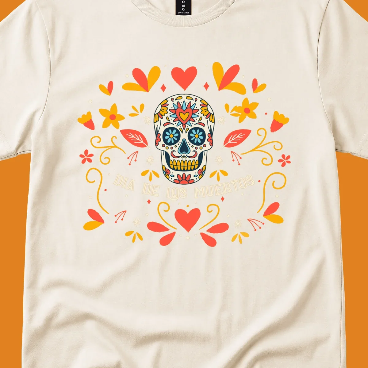 A colorful Día de los Muertos sugar skull with a heart on its forehead, surrounded by a symmetrical frame of red hearts, yellow flowers, and leaves, with 'DIA DE LOS MUERTOS' text below.