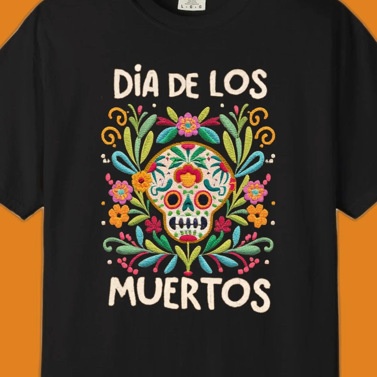 An embroidered-style Día de los Muertos sugar skull with colorful flowers and leaves, and the text "DÍA DE LOS MUERTOS".