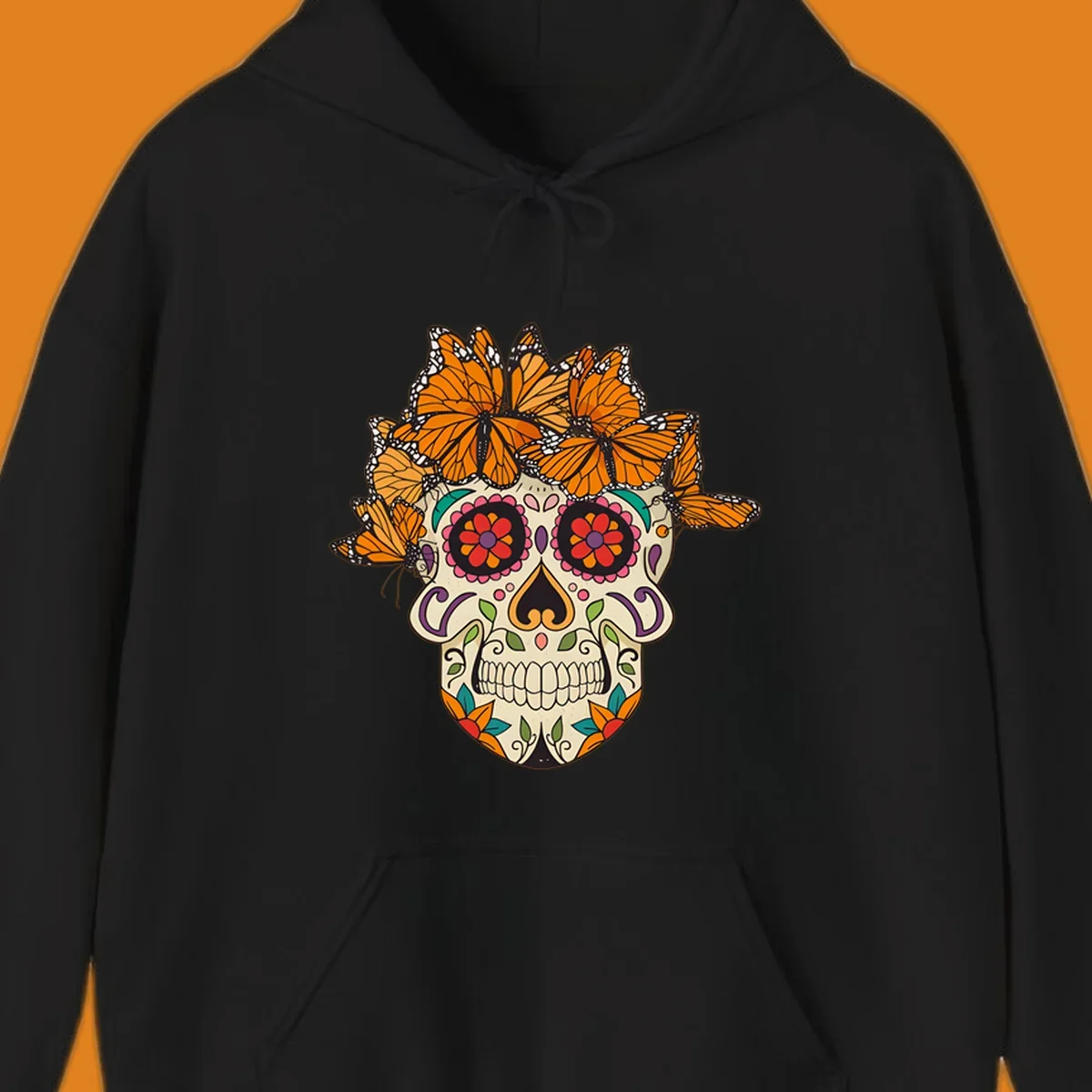 A cream sugar skull with colorful floral patterns and a crown of orange and black monarch butterflies.