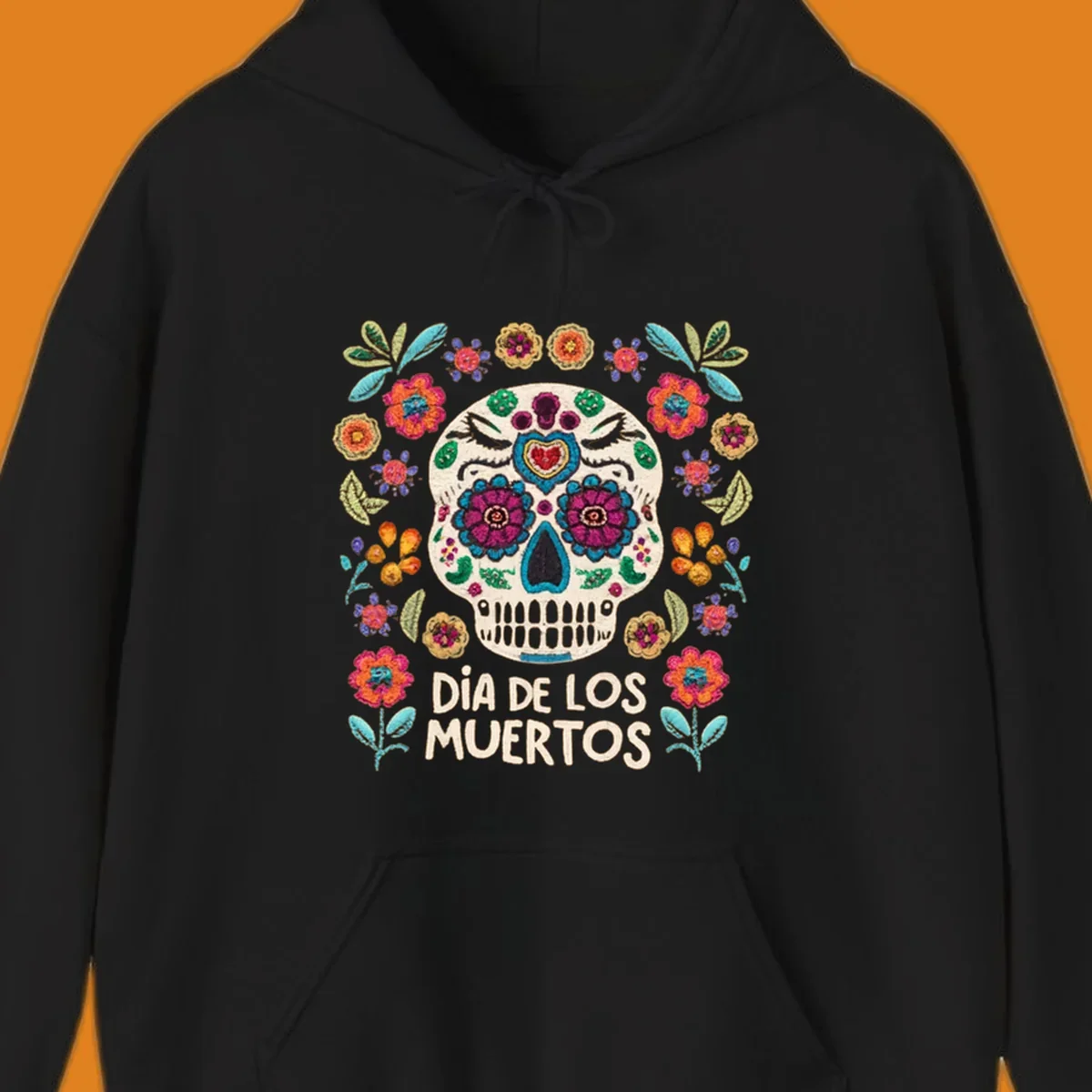 Embroidered-style Día de los Muertos sugar skull with colorful flowers and leaves, and text 'DÍA DE LOS MUERTOS'.