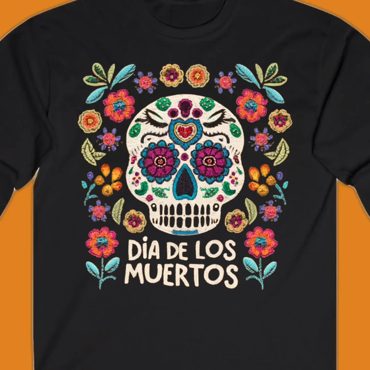Embroidered-style Día de los Muertos sugar skull with colorful flowers and leaves, and text 'DÍA DE LOS MUERTOS'.
