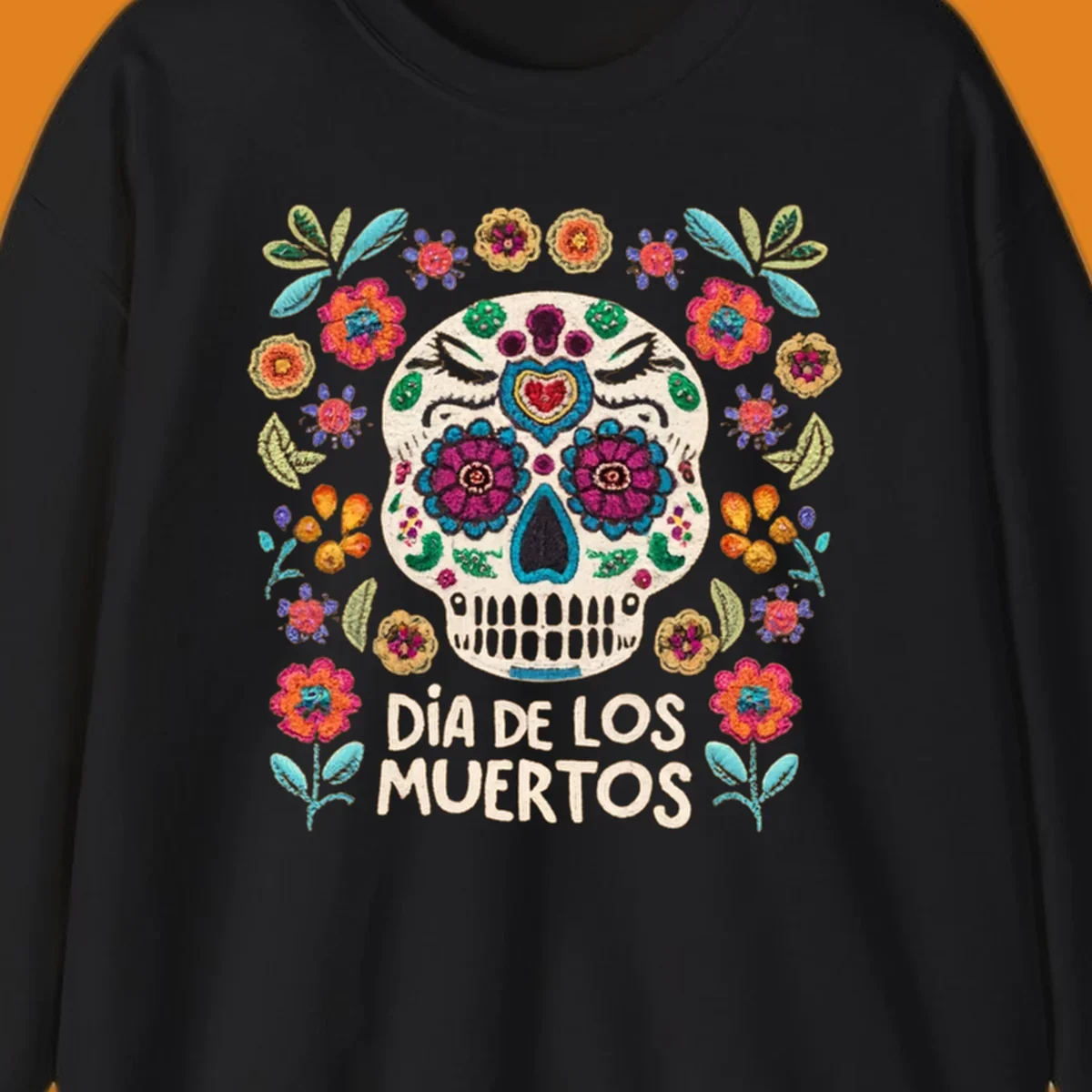 Embroidered-style Día de los Muertos sugar skull with colorful flowers and leaves, and text 'DÍA DE LOS MUERTOS'.
