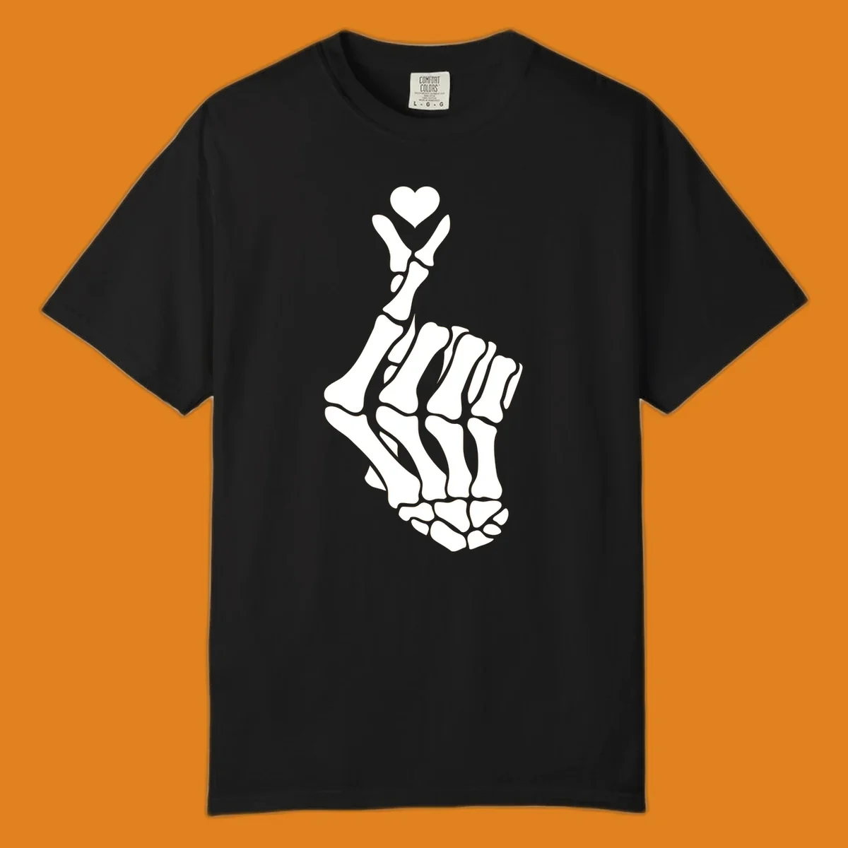A white skeleton hand forms the Korean finger heart gesture, with a small heart shape at the fingertips. Concept: skeleton-finger-heart.