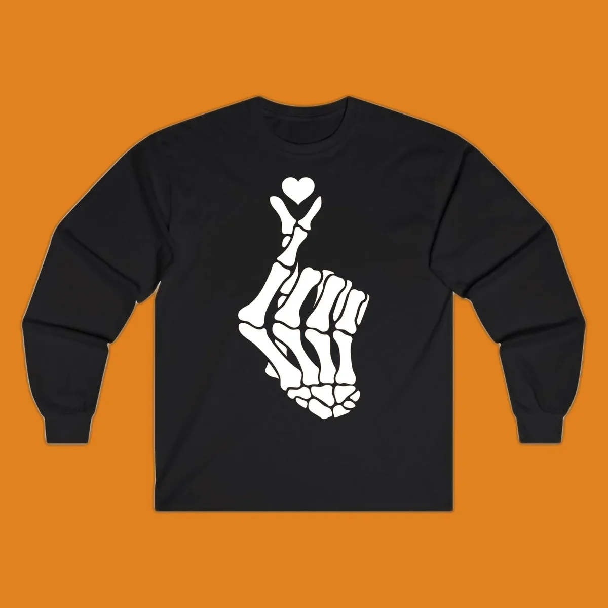 A white skeleton hand forms the Korean finger heart gesture, with a small heart shape at the fingertips. Concept: skeleton-finger-heart.