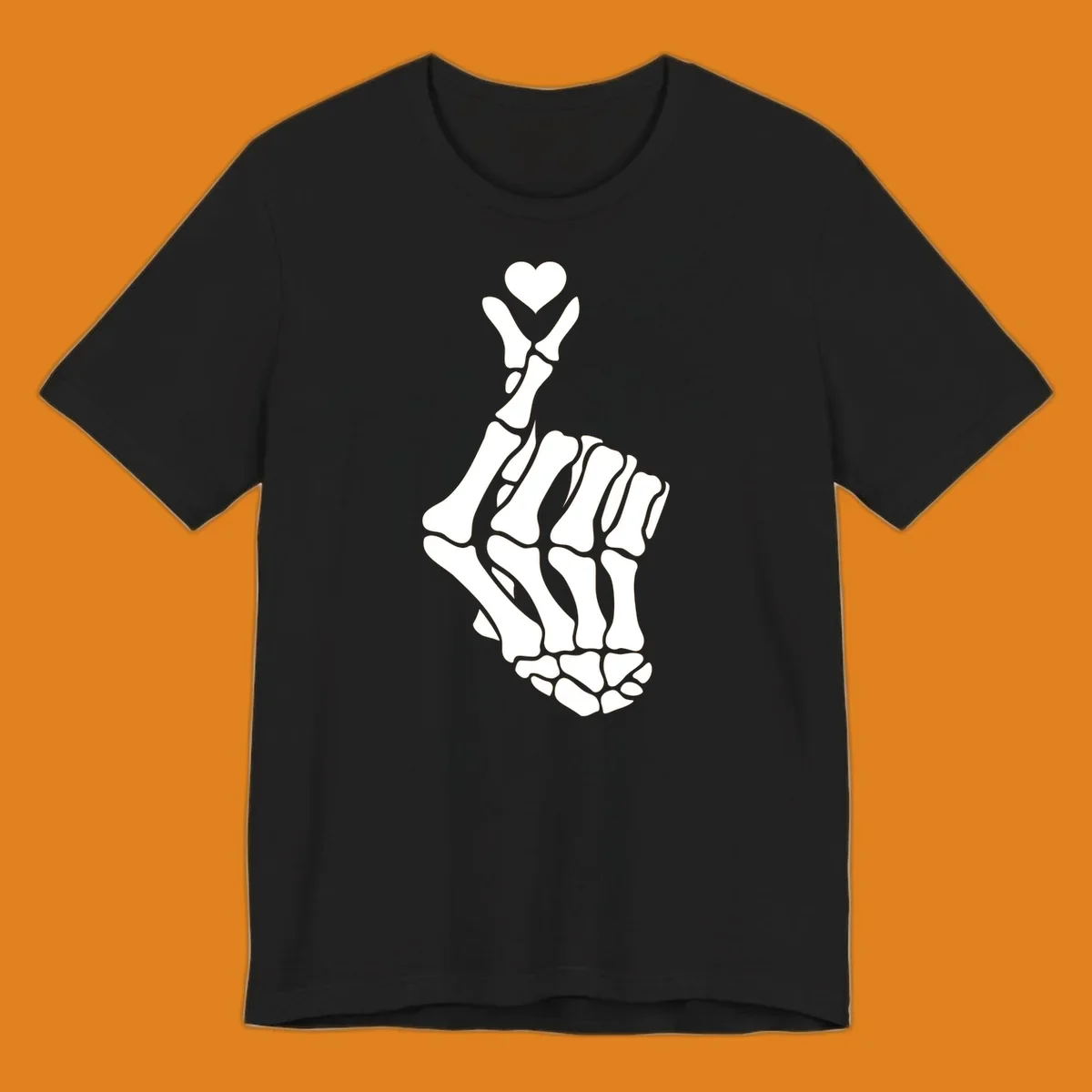 A white skeleton hand forms the Korean finger heart gesture, with a small heart shape at the fingertips. Concept: skeleton-finger-heart.