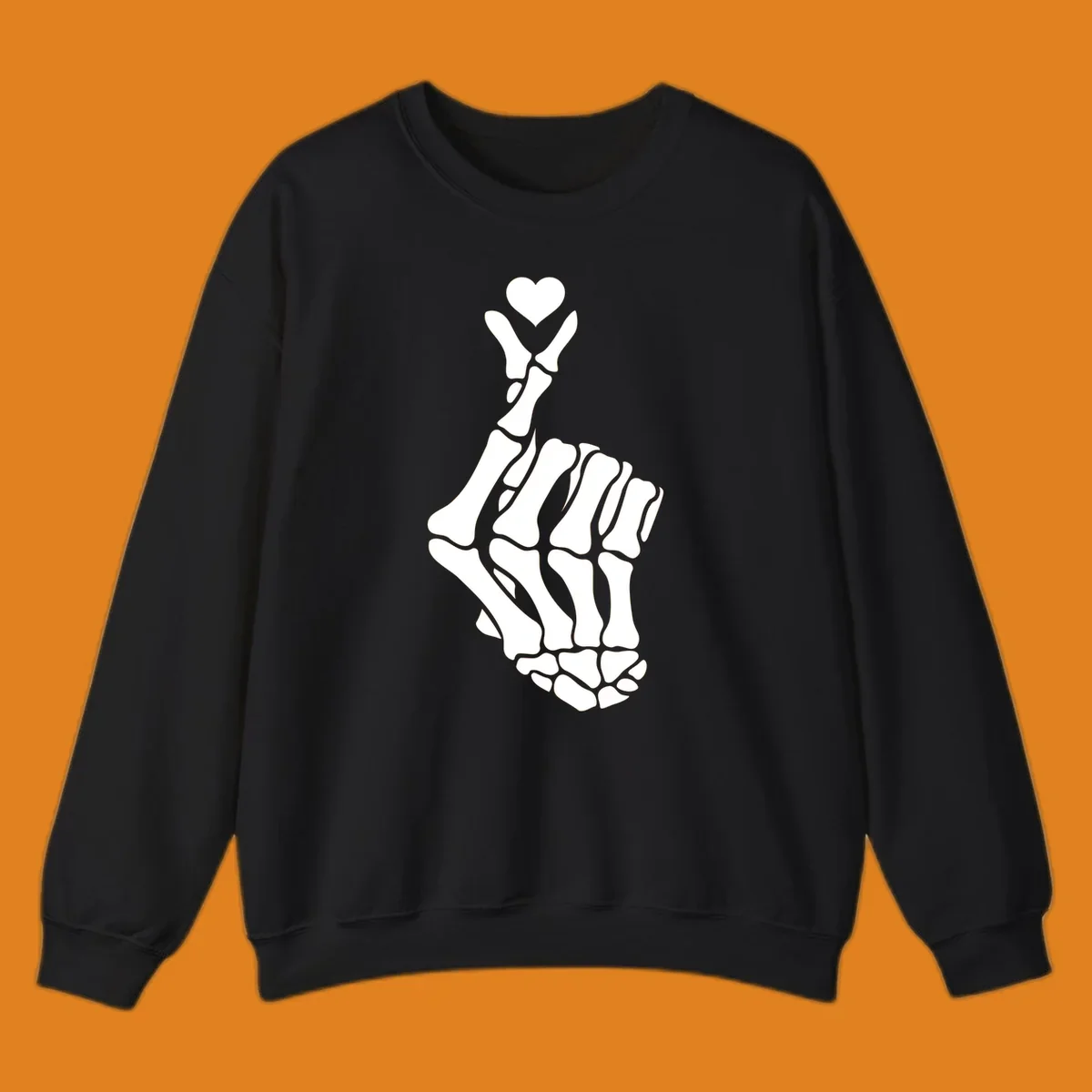 A white skeleton hand forms the Korean finger heart gesture, with a small heart shape at the fingertips. Concept: skeleton-finger-heart.