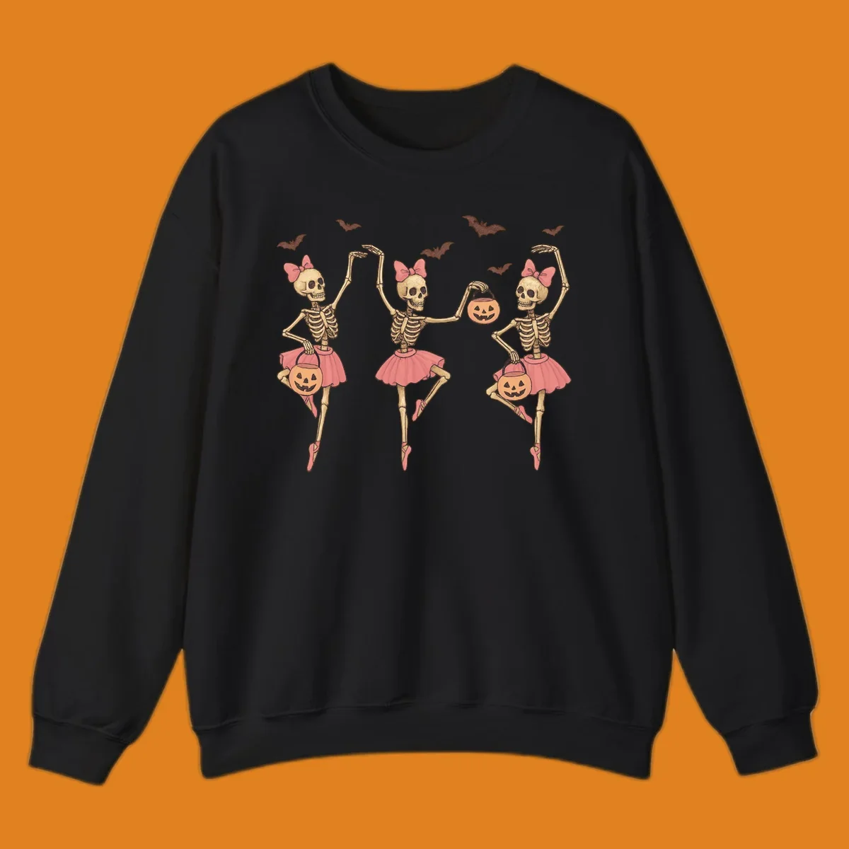 Skeleton ballerinas in tutus with pumpkins and bats, perfect for Halloween.