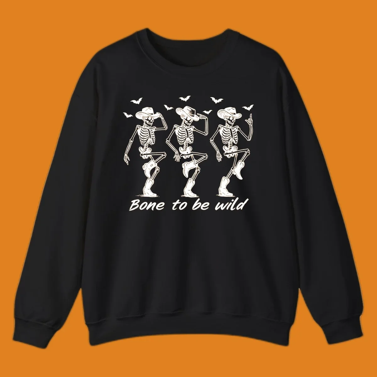 Three dancing skeletons in cowboy hats and boots with bats and the phrase 'Bone to be wild', bone-to-be-wild-cowboy