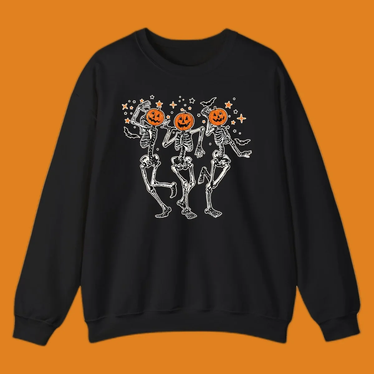 Dancing skeletons with pumpkin heads, bats, and stars illustration for Halloween.