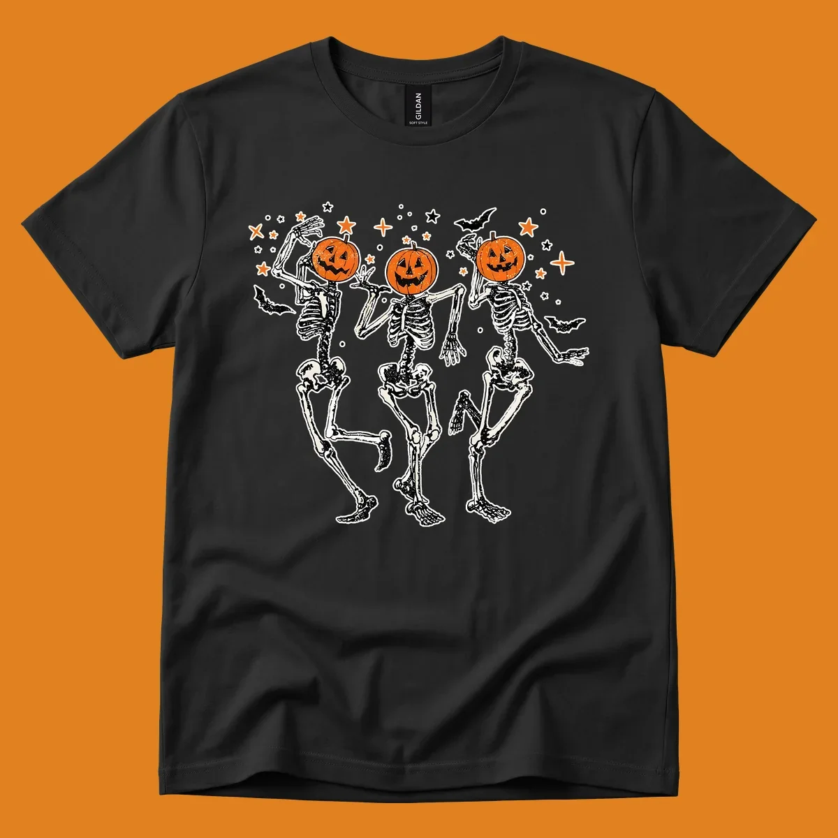 Dancing skeletons with pumpkin heads, bats, and stars illustration for Halloween.